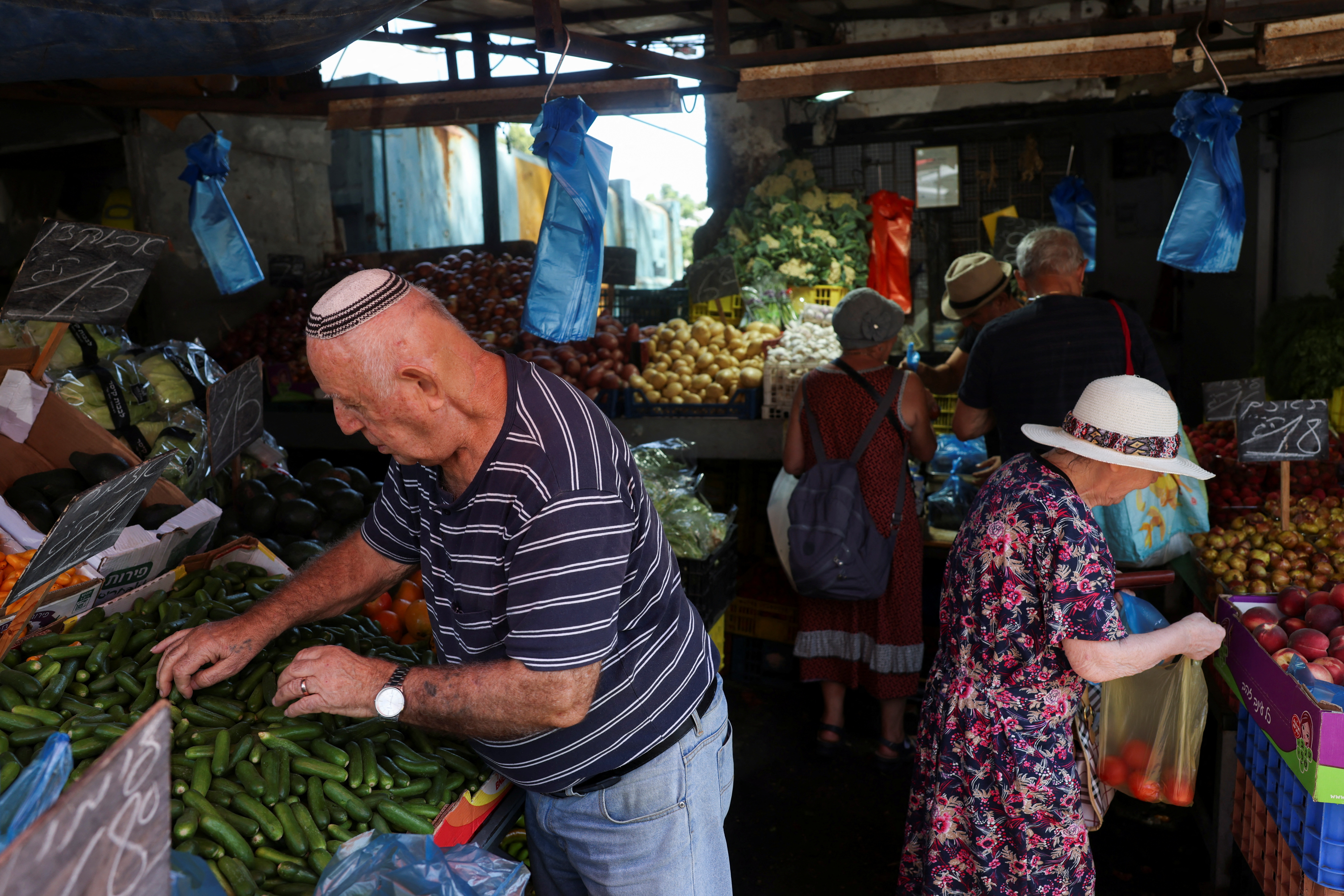 People shop in a market, amid rising tensions between Israel and Hezbollah, in Haifa