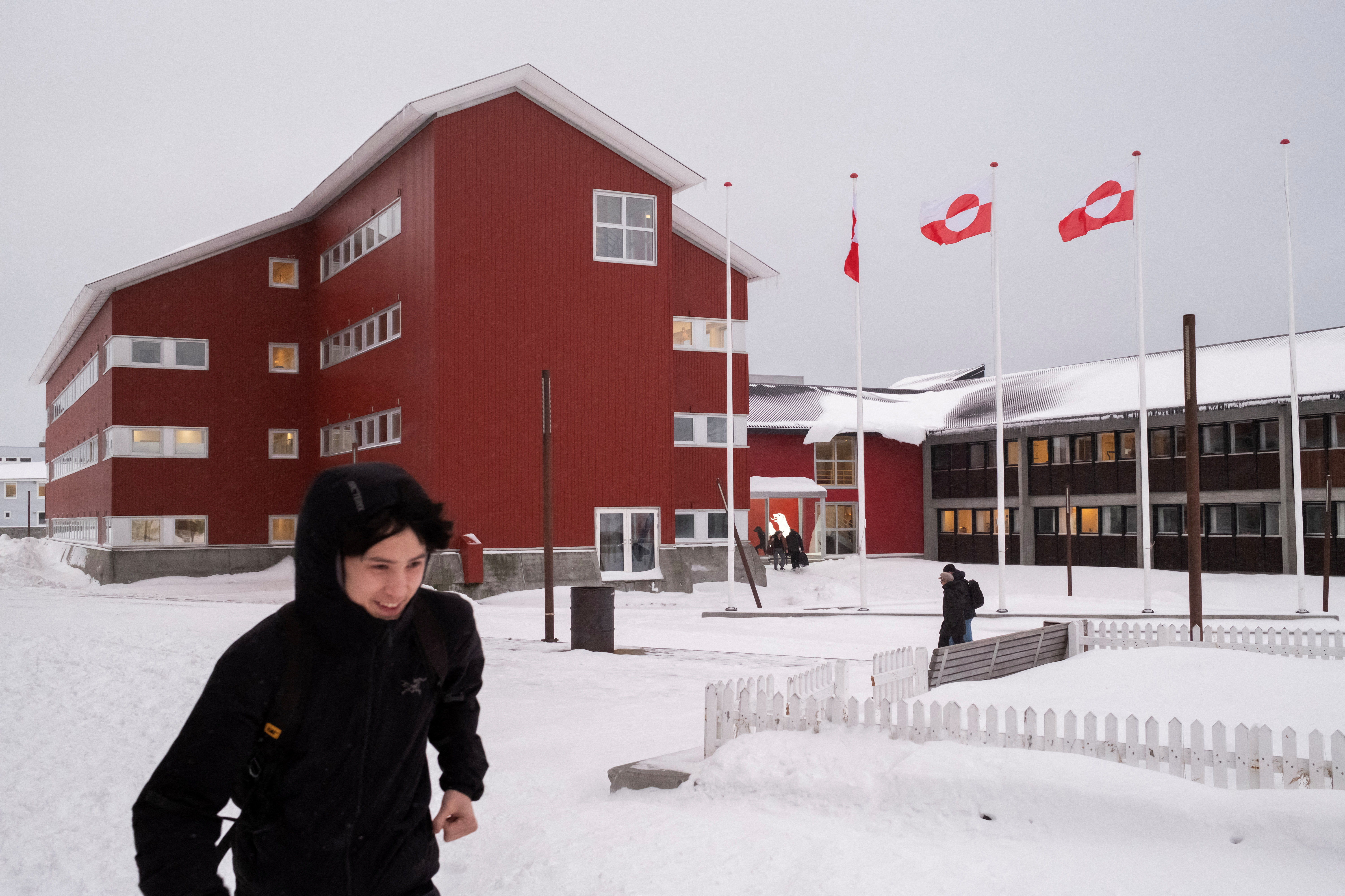 People walk in front of Greenland's parliament Inatsisartut in Nuuk