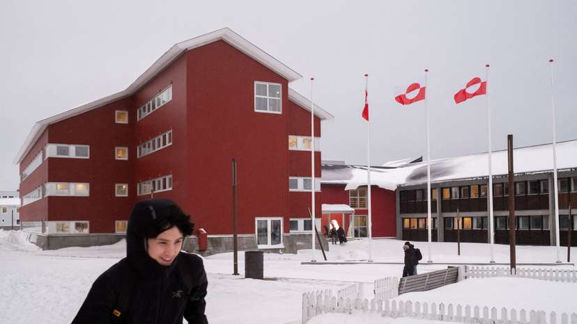 People walk in front of Greenland's parliament Inatsisartut in Nuuk