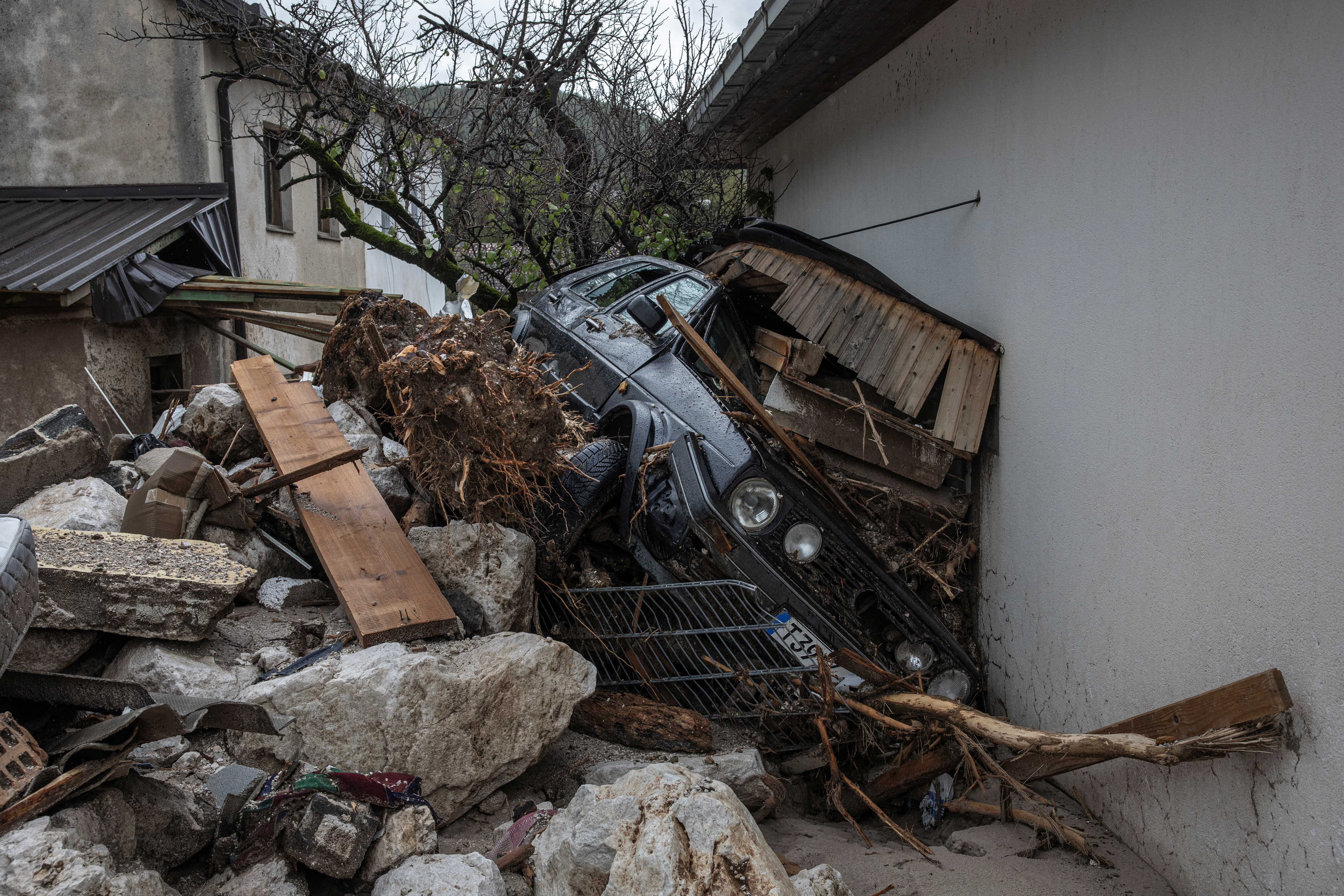 A destroyed car is seen following a landslide in the flooded village of Donja Jablanica