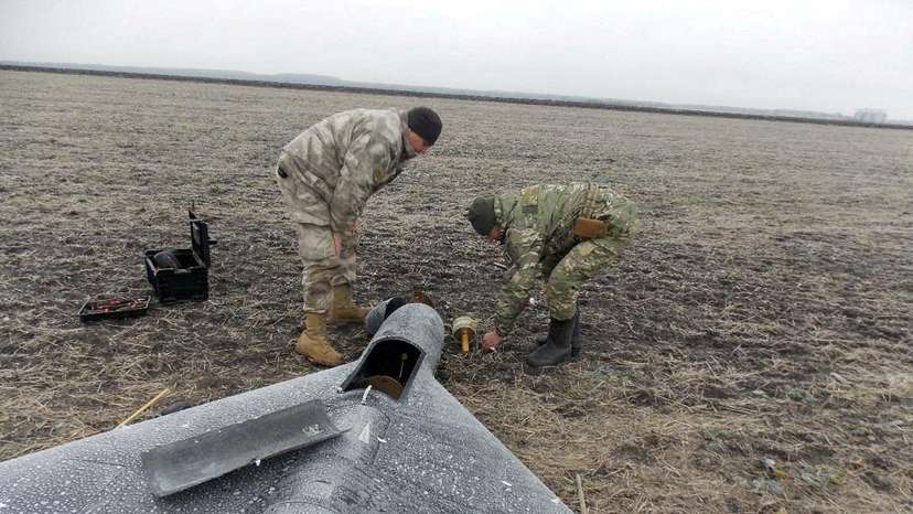 FILE PHOTO: Members of police demining unit remove a warhead from a Russian kamikaze unmanned aerial vehicle landed by a radio electronic warfare during one of latest drone strikes in an unknown location in Ukraine