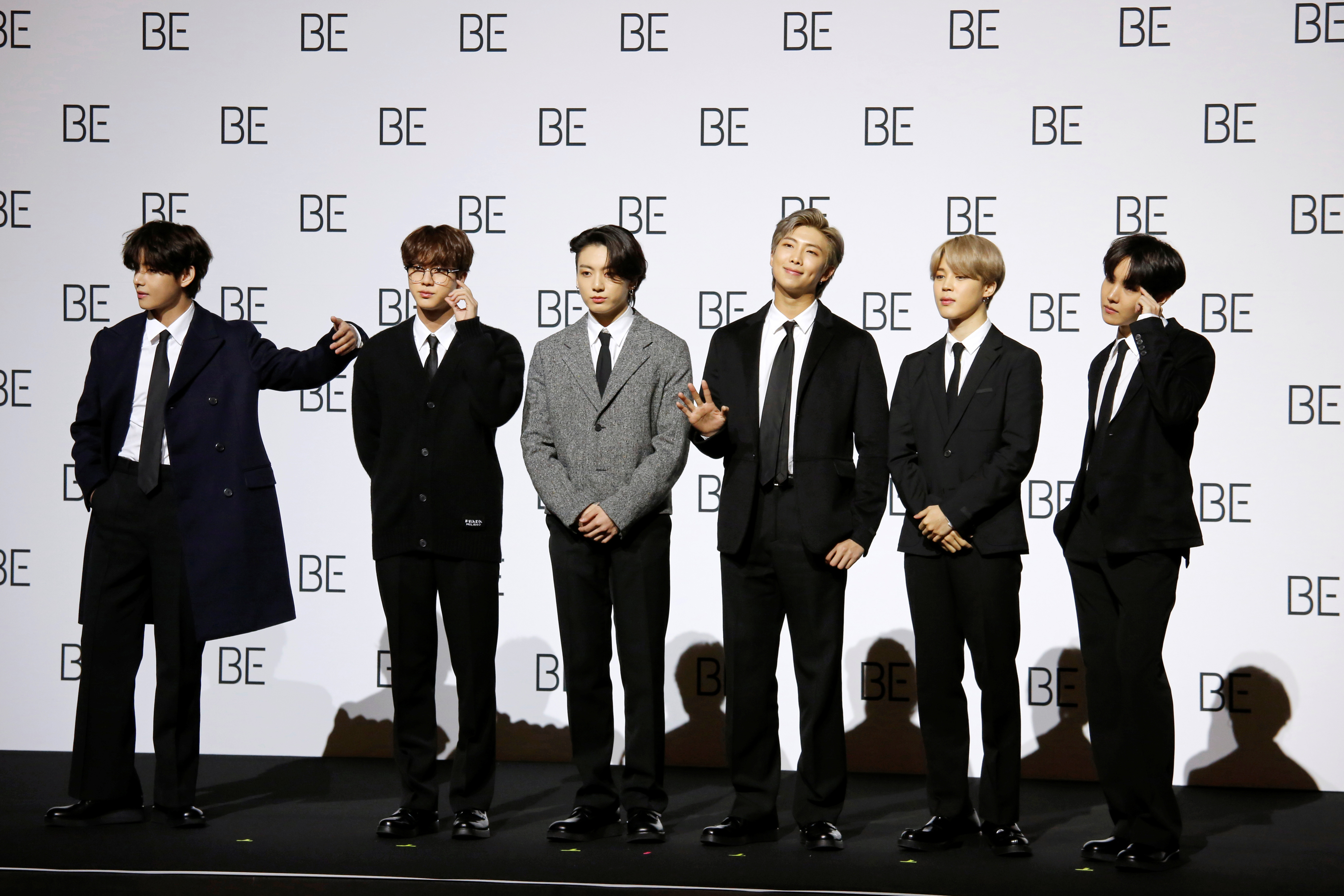 Members of K-pop boy band BTS pose for photographs during a news conference promoting their new album "BE(Deluxe Edition)" in Seoul