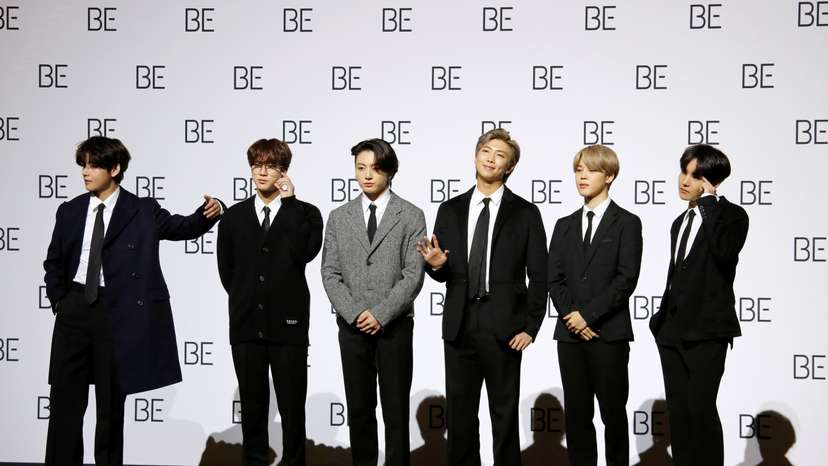 Members of K-pop boy band BTS pose for photographs during a news conference promoting their new album "BE(Deluxe Edition)" in Seoul