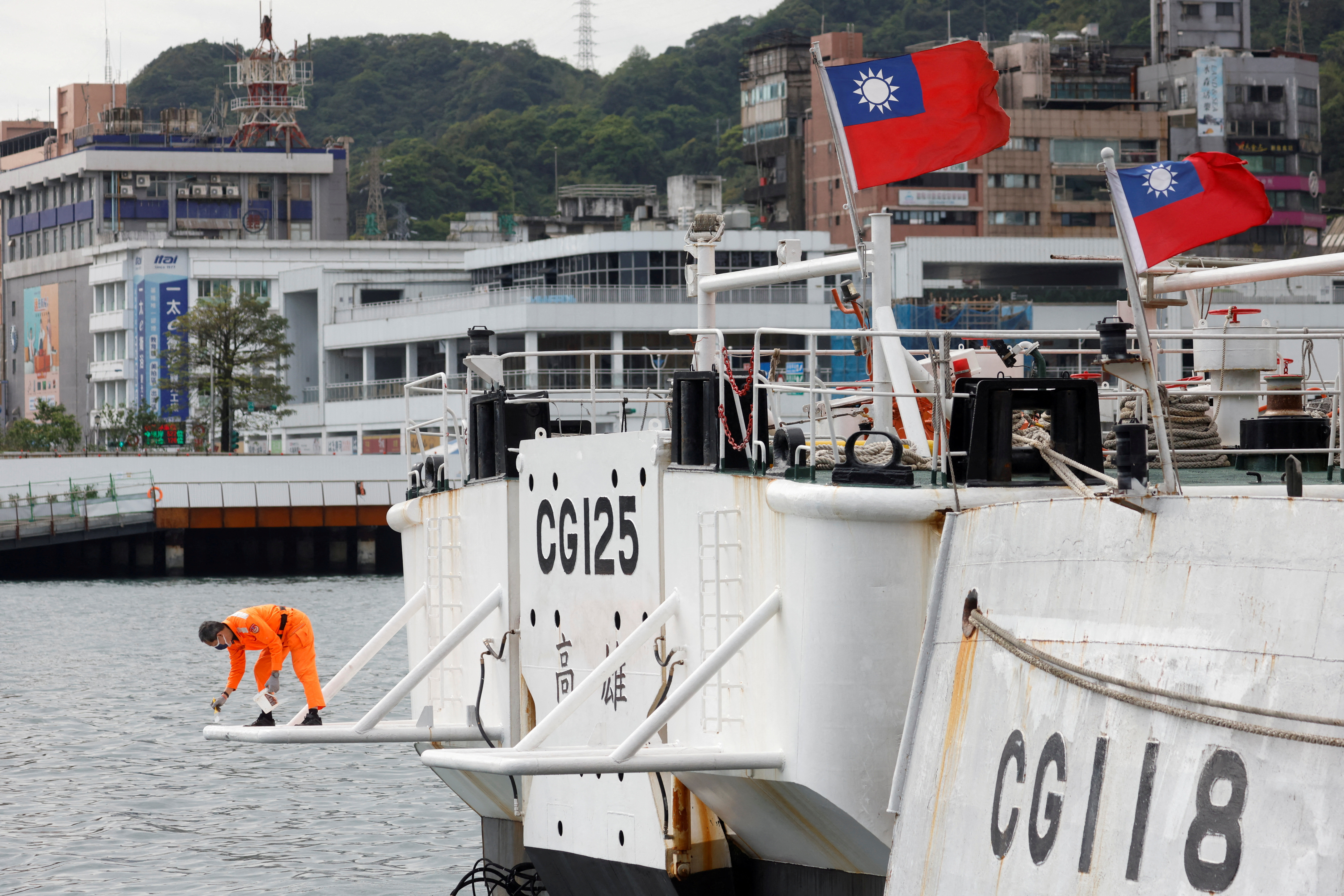 FILE PHOTO: A crew member works aboard a Taiwanese Coast Guard vessel ducked at the port in Keelung