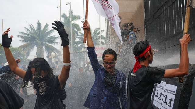 Protest outside the Indonesian Parliament against revisions to the country's military law, in Jakarta