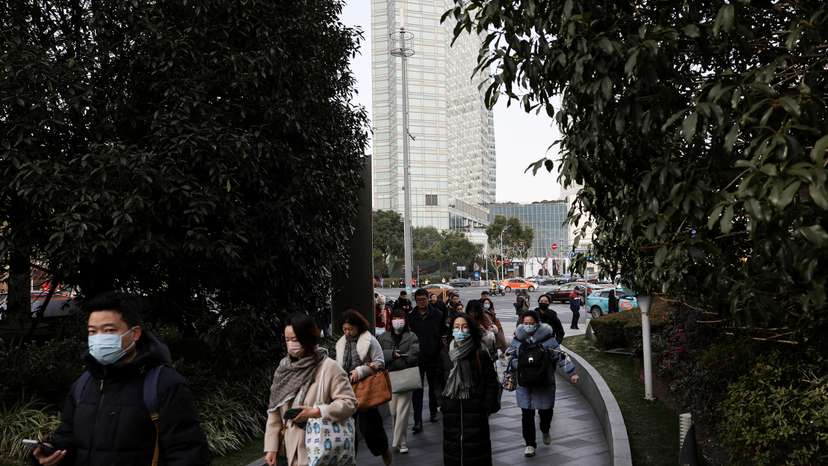 People walk in the Pudong financial district after Lunar New Year holiday in Shanghai