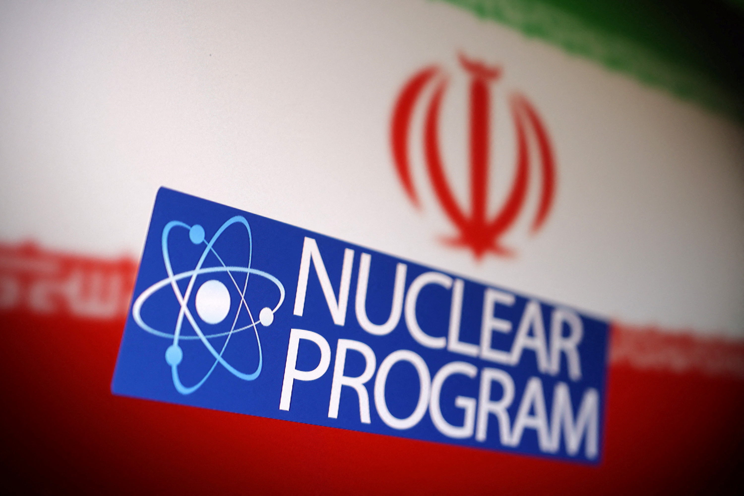 Illustration shows Iranian flag, atom symbol and words "Nuclear program\