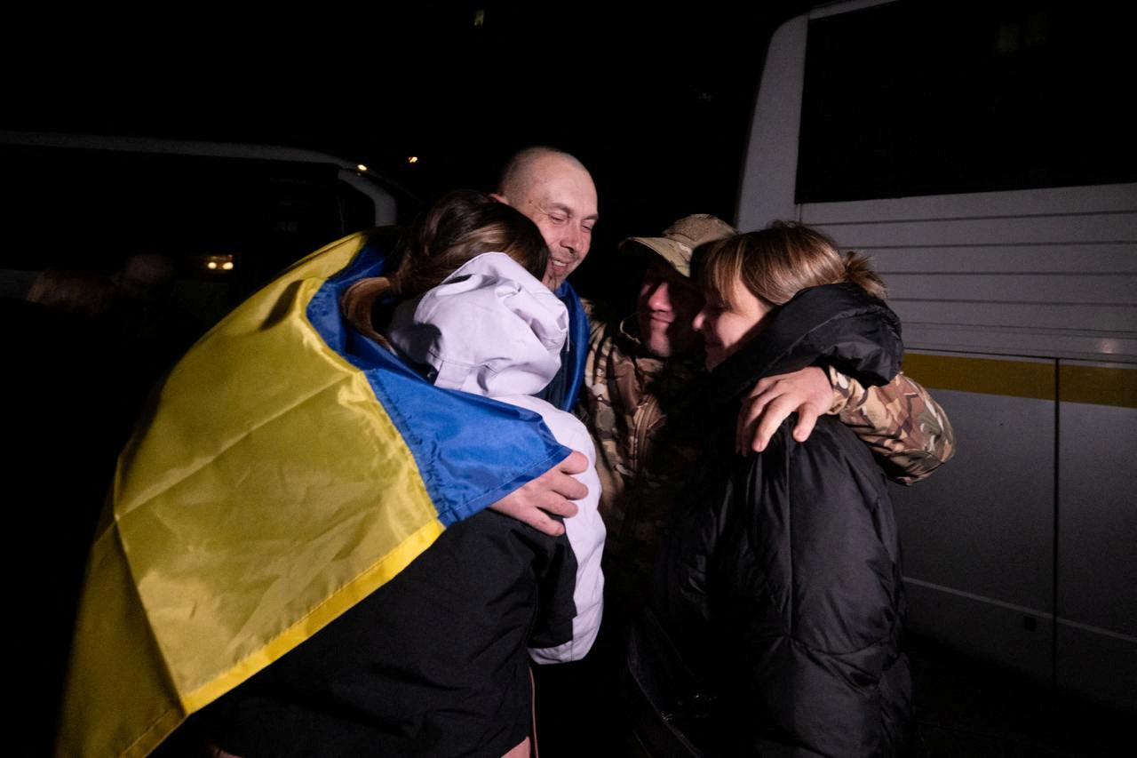 Ukrainian POW embraces his relatives after a swap in an undisclosed location in Ukraine