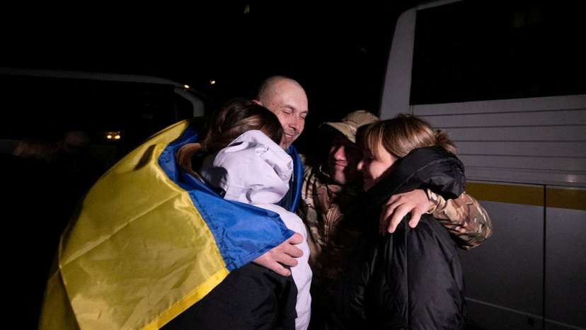 Ukrainian POW embraces his relatives after a swap in an undisclosed location in Ukraine