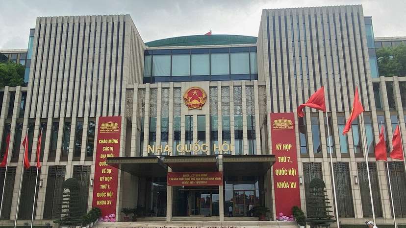 A man cycles in front of the National Assembly Building of Vietnam, in Hanoi