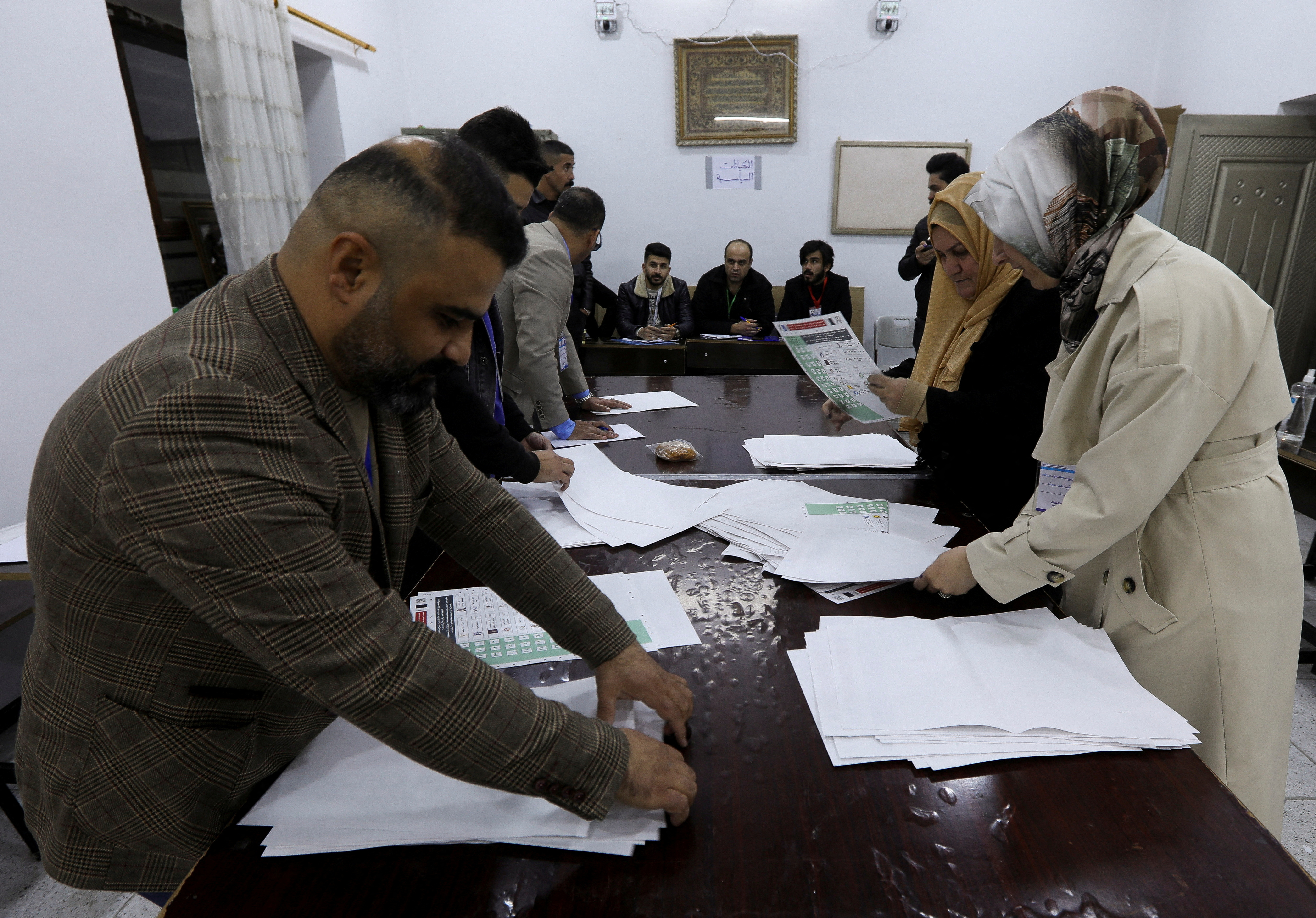 FILE PHOTO: Officials sort ballot papers after the closing of the polling station during Iraq's provincial council elections, in Kirkuk