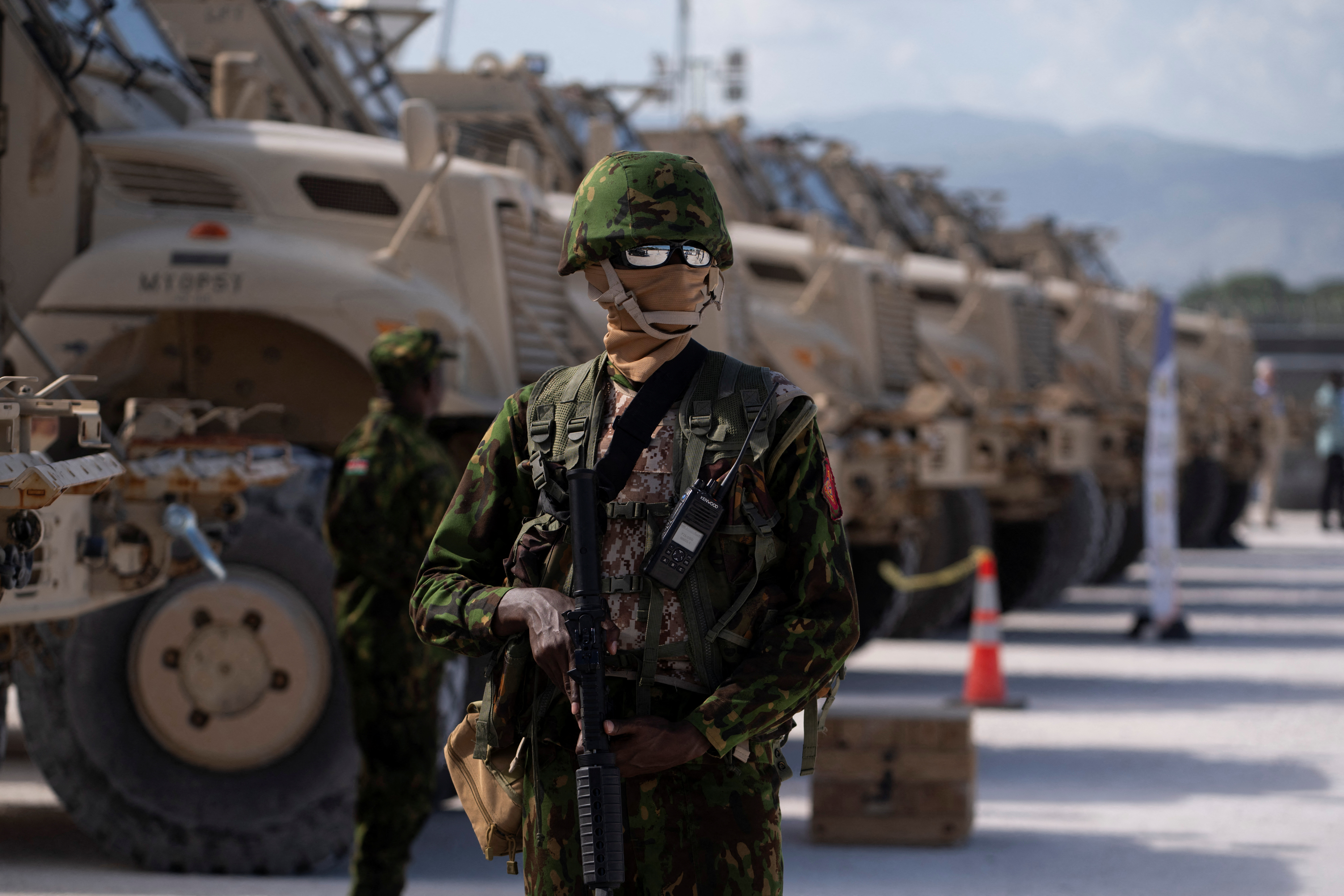 FILE PHOTO: A Kenyan police officer stands next to a row of anti-mine armoured vehicles as the United States Ambassador to the United Nations Linda Thomas-Greenfield tours the Multinational Security Support (MSS) mission in Haiti