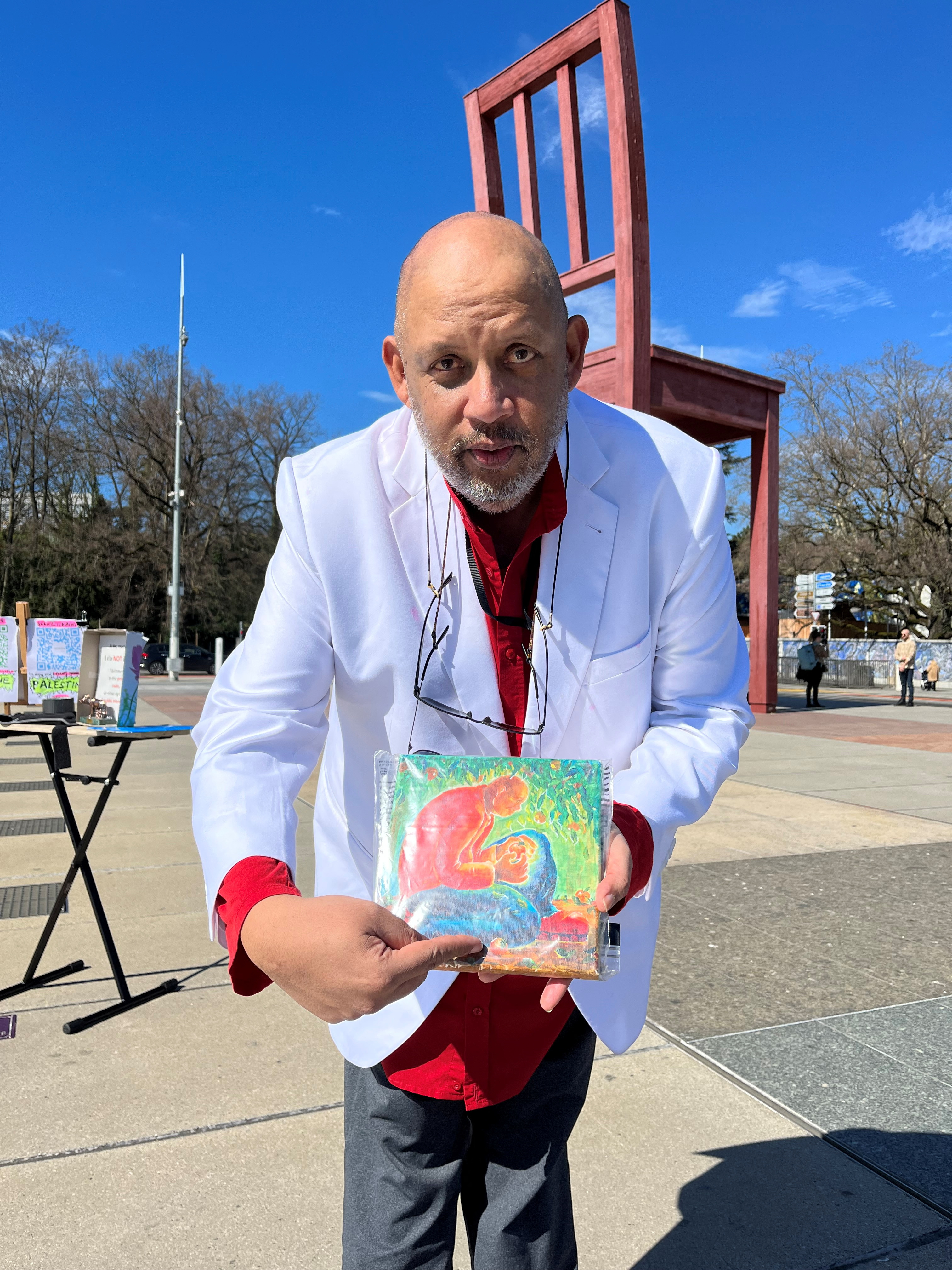 FILE PHOTO: Bruno Donat holds up a painting by a Gazan artist during a hunger strike for children affected during the conflict between Israel and Hamas, in Geneva