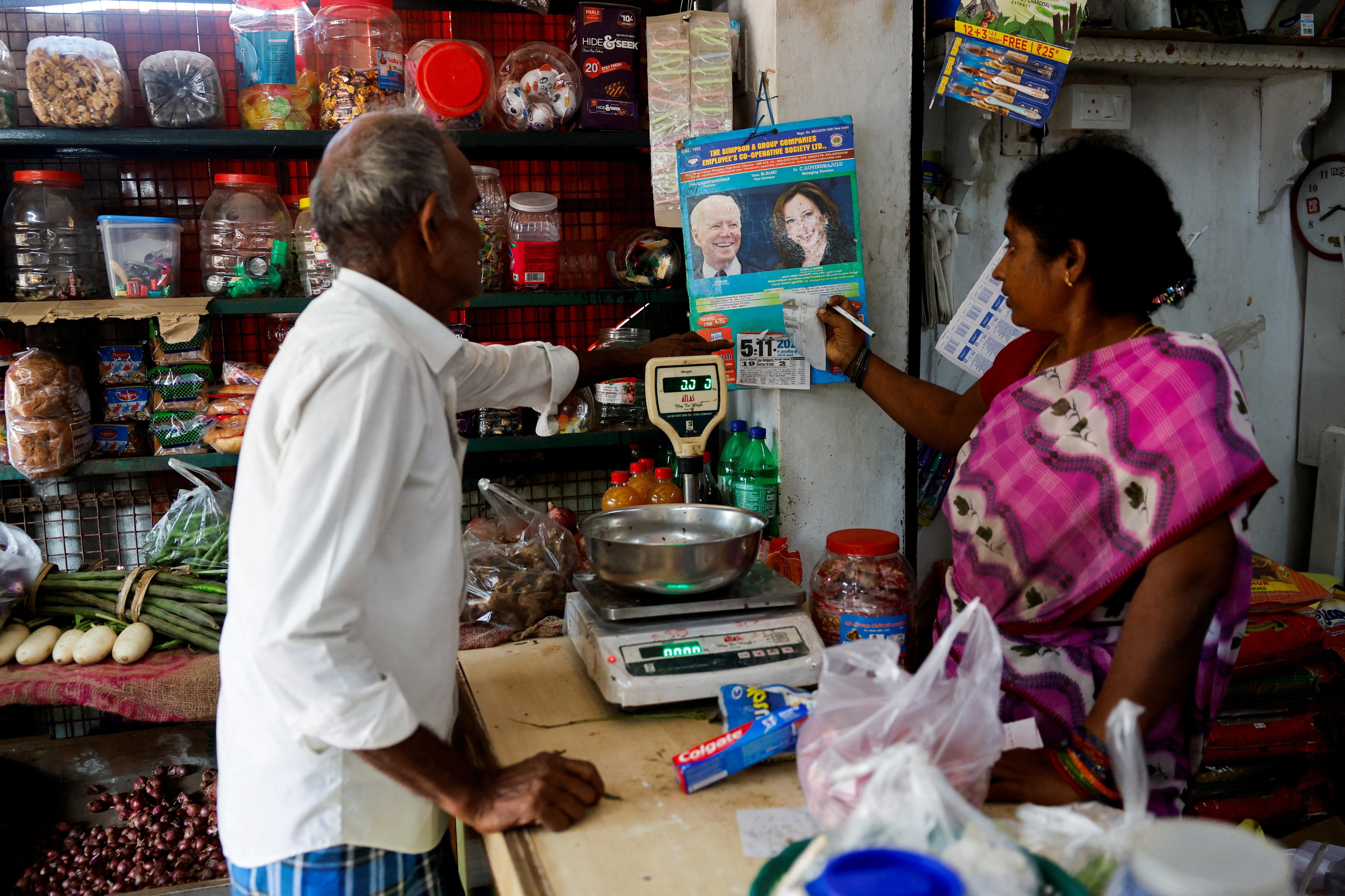 A calendar with images of U.S. President Joe Biden and Democratic presidential nominee, U.S. Vice President Kamala Harris is hung inside a shop in Thulasendrapuram