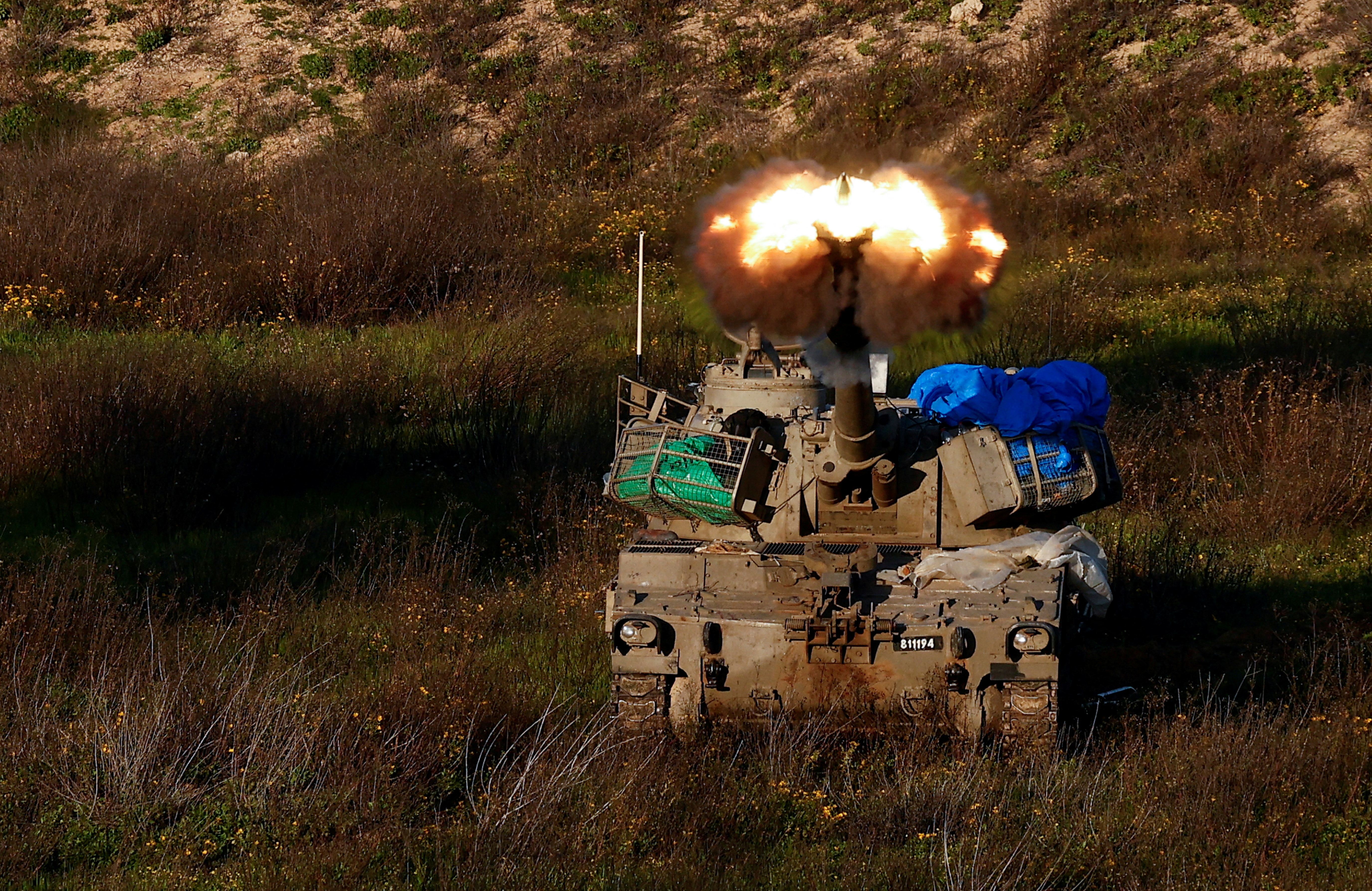 An Israeli artillery unit fires towards Gaza, near the northern Gaza Strip border