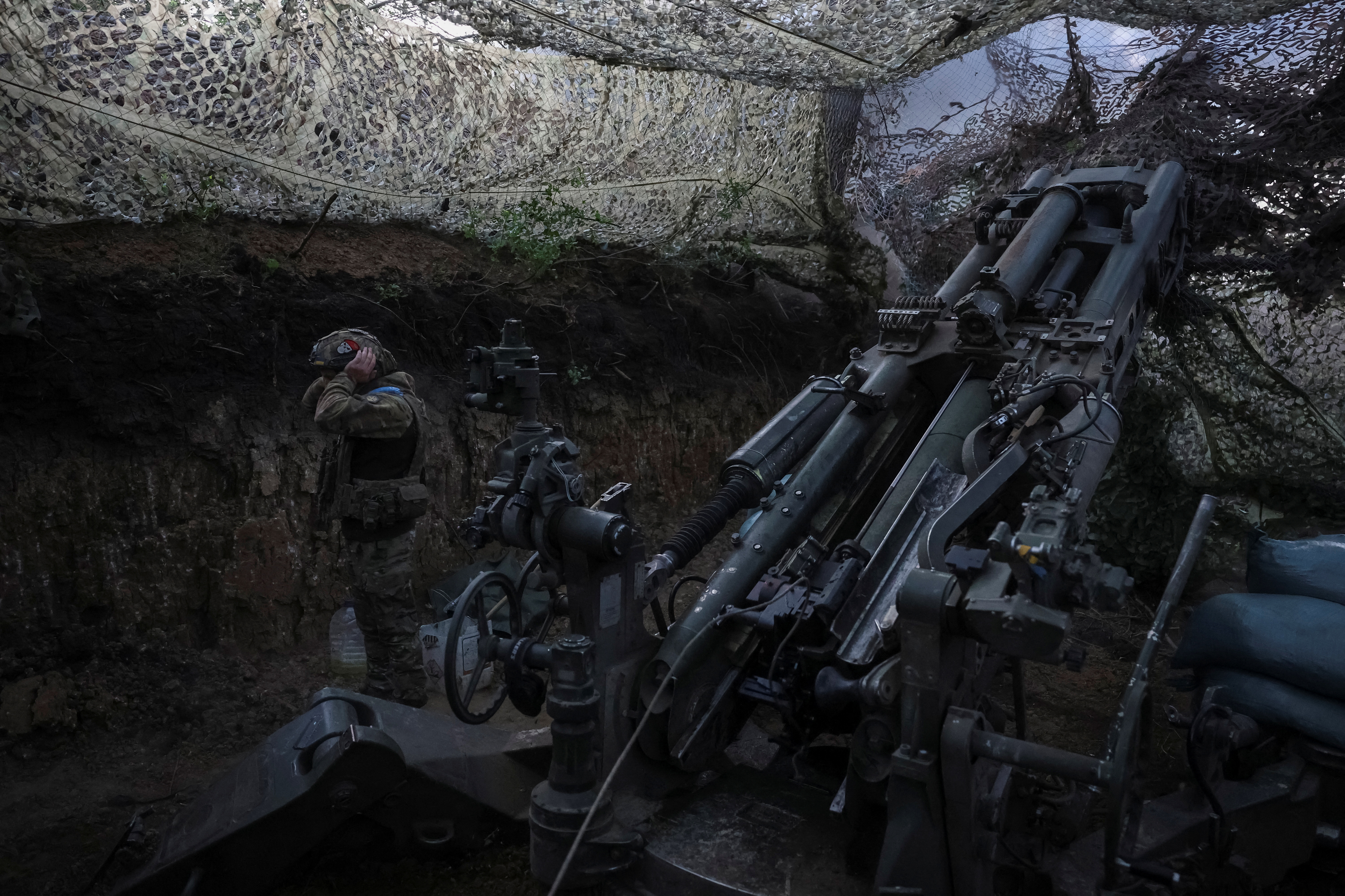 Servicemen fire a howitzer towards Russian troops at position on front line in Donetsk region