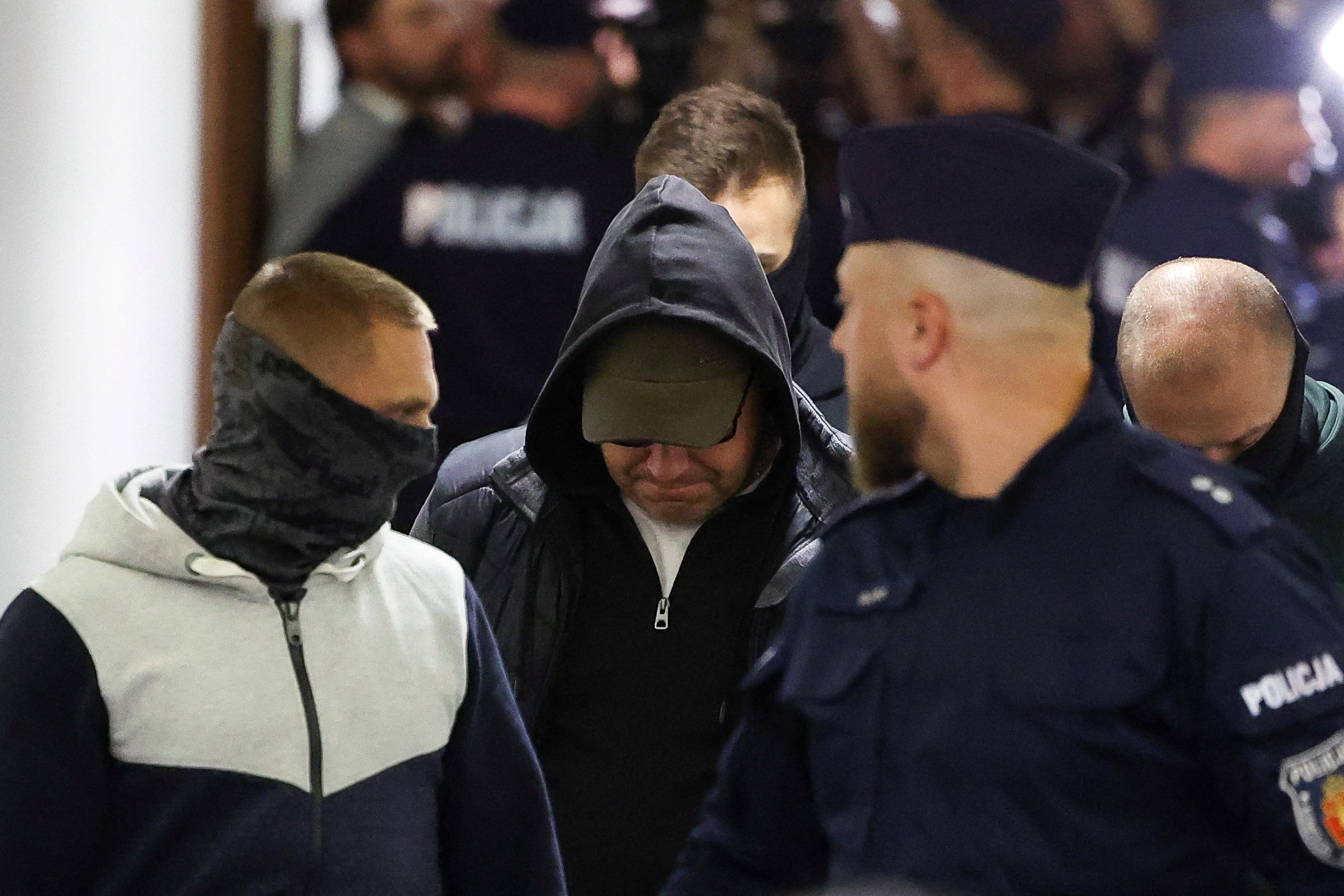 A Ukrainian diver, Volodymyr Z., wanted by Germany over his alleged involvement in the 2022 explosions that damaged the Nord Stream pipeline, walks escorted by Polish Police at the district court