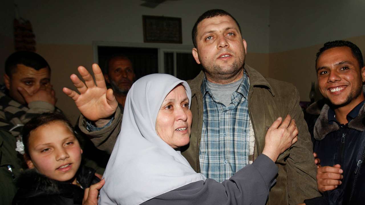 Ayman Nofal, a top Hamas armed commander, is greeted by his relatives upon his arrival to his home in Nusairat in the Central Gaza strip
