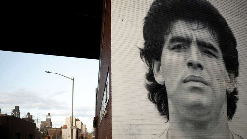 A man walks past a mural depicting late Argentine football legend Diego Maradona in New York City