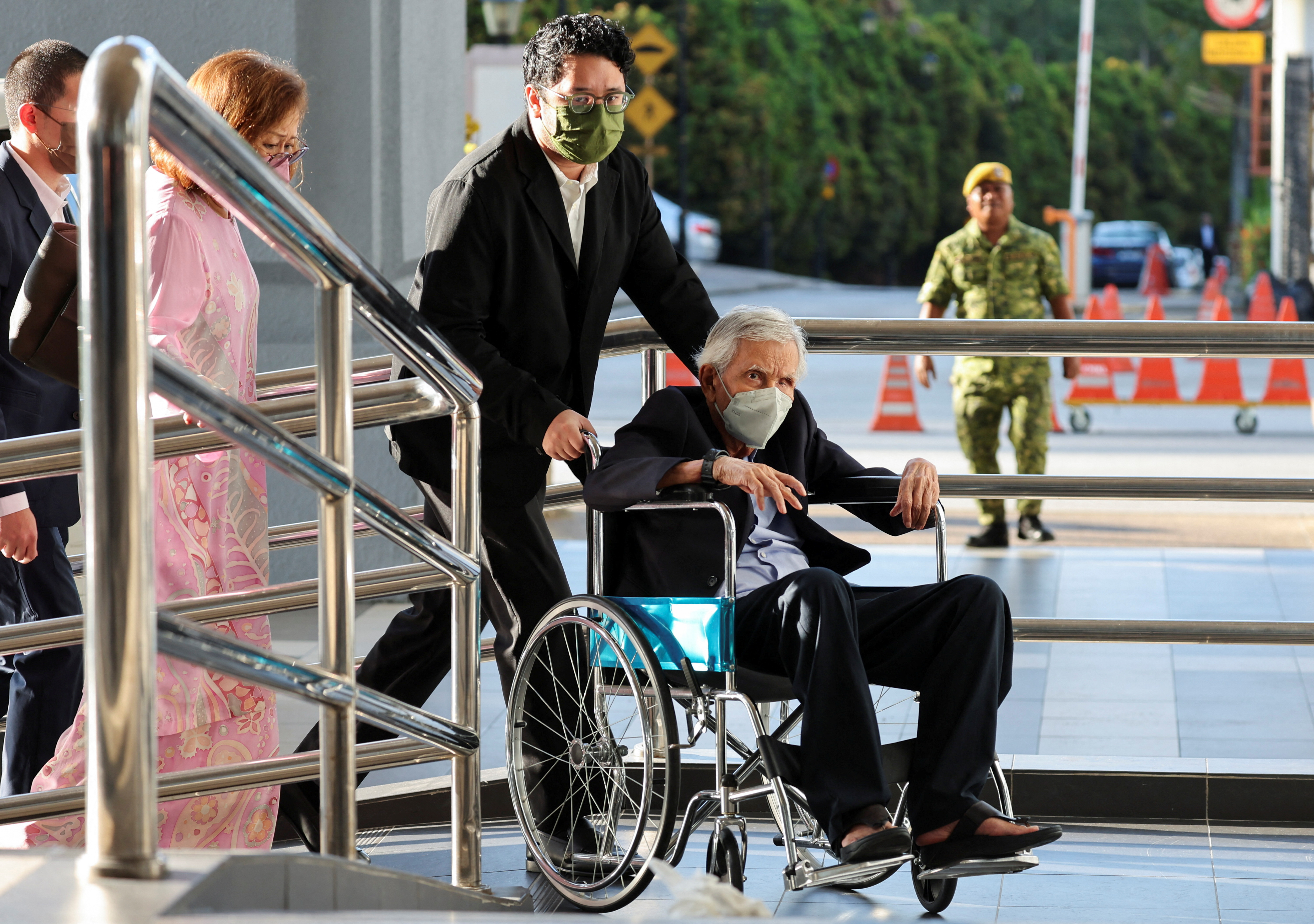 Malaysia's former finance minister Daim Zainuddin arrives at the Kuala Lumpur court complex in Kuala Lumpur