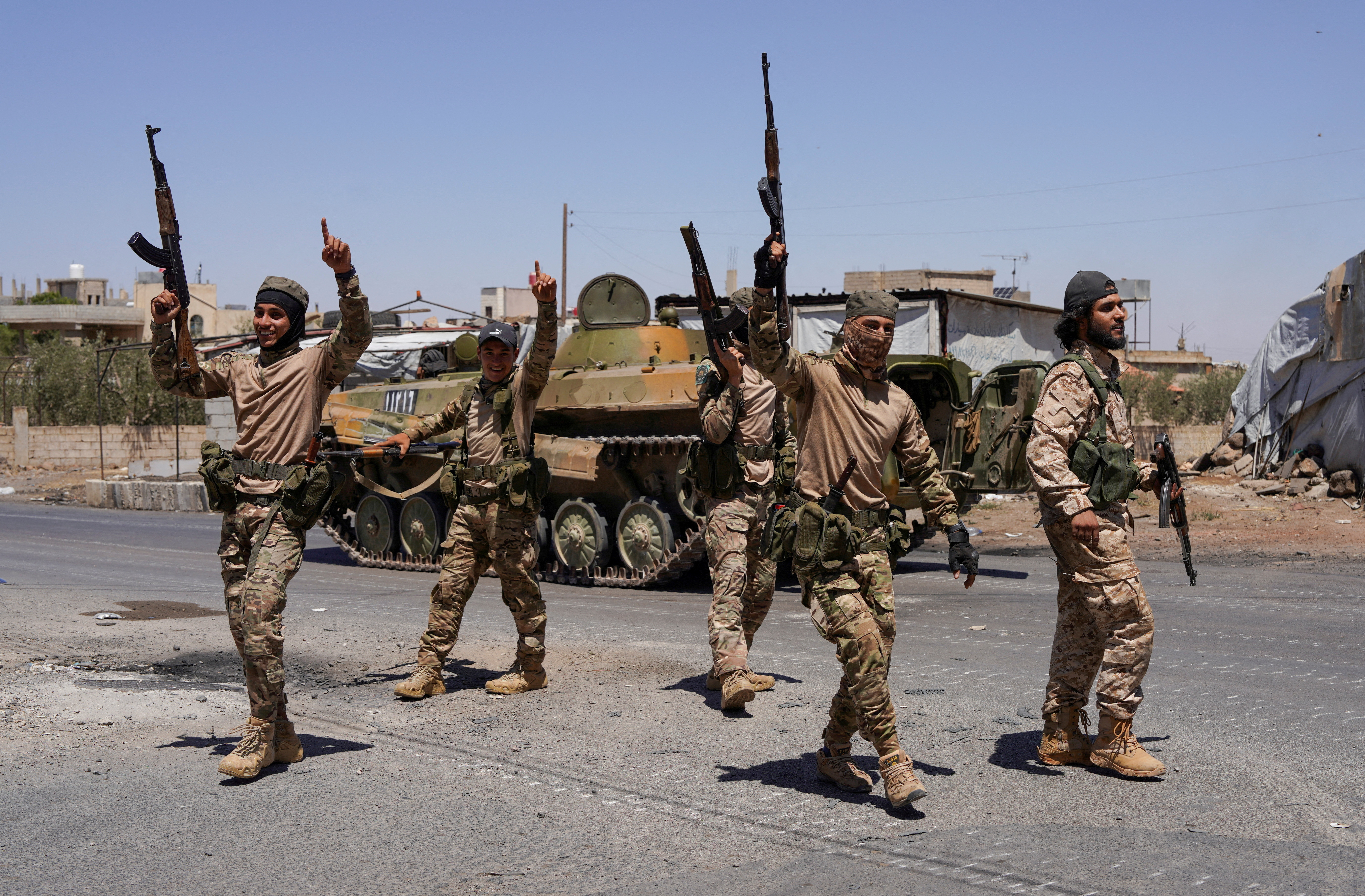 FILE PHOTO: Syrian security forces walk together along a street in Sweida