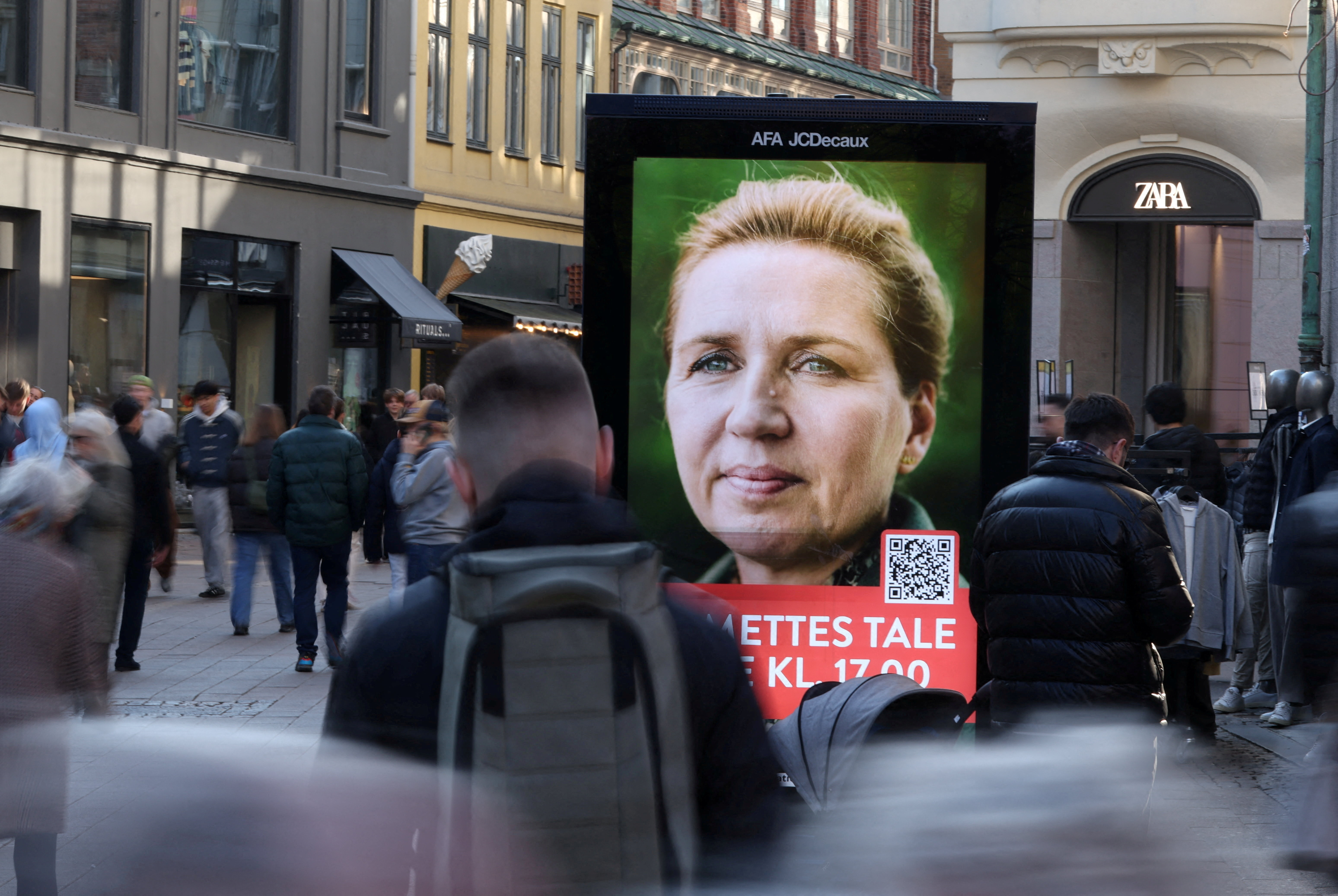 People pass an election advertisement for Mette Frederiksen in Copenhagen