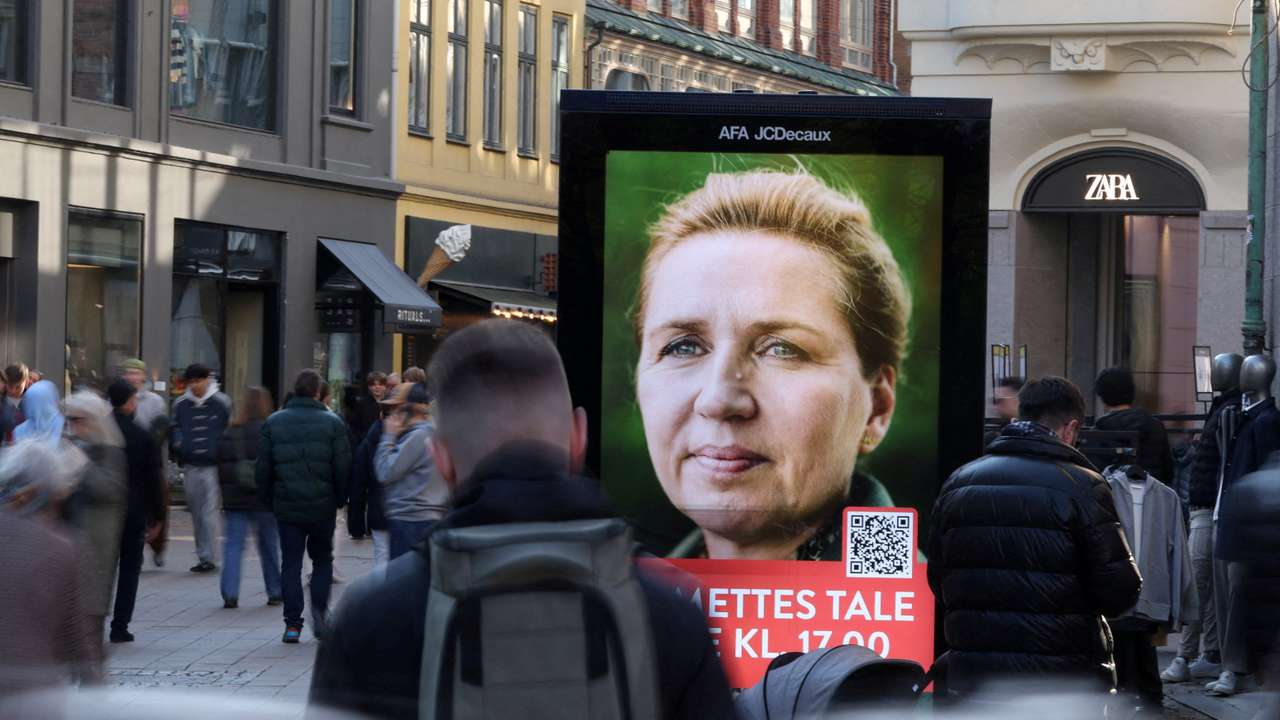People pass an election advertisement for Mette Frederiksen in Copenhagen