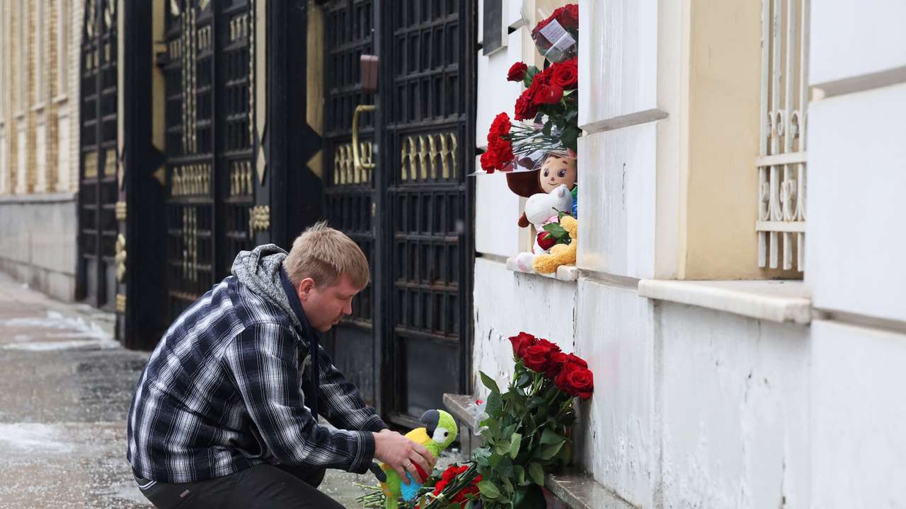 People bring flowers and toys to the Iranian embassy in Moscow