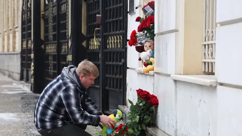 People bring flowers and toys to the Iranian embassy in Moscow