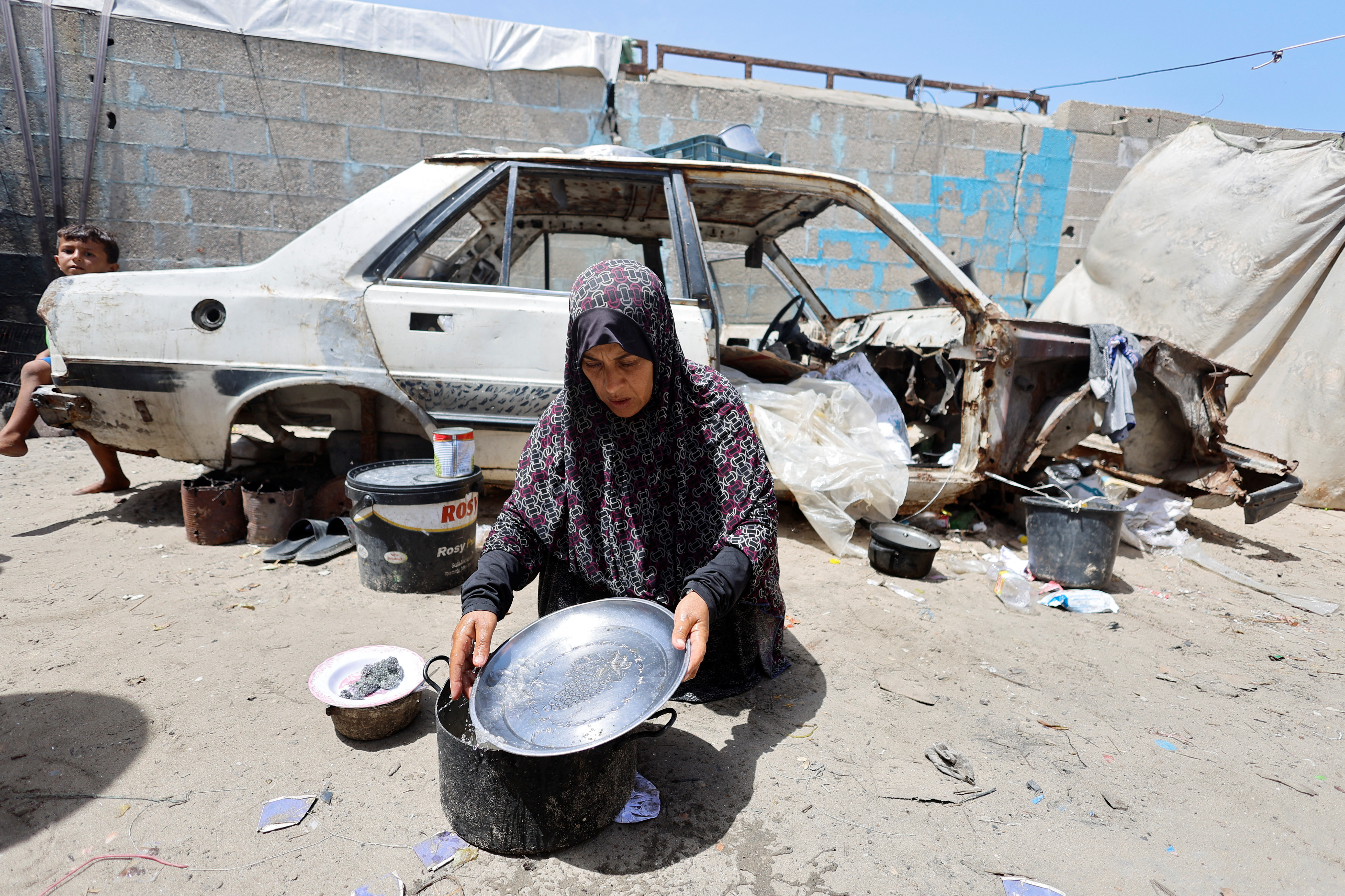 Displaced Palestinians, who fled their house due to Israel's military offensive shelter in a tent, in Rafah