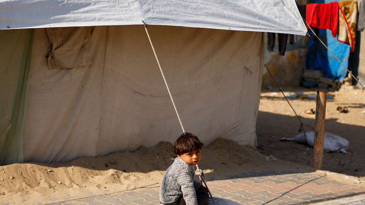Displaced Palestinians, who fled their houses due to Israeli strikes, shelter at a tent camp, in Rafah
