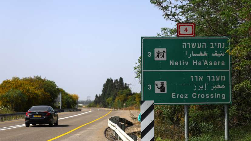 A car passes by an Erez Crossing signboard, after the Israeli cabinet approved the reopening of the crossing into northern Gaza