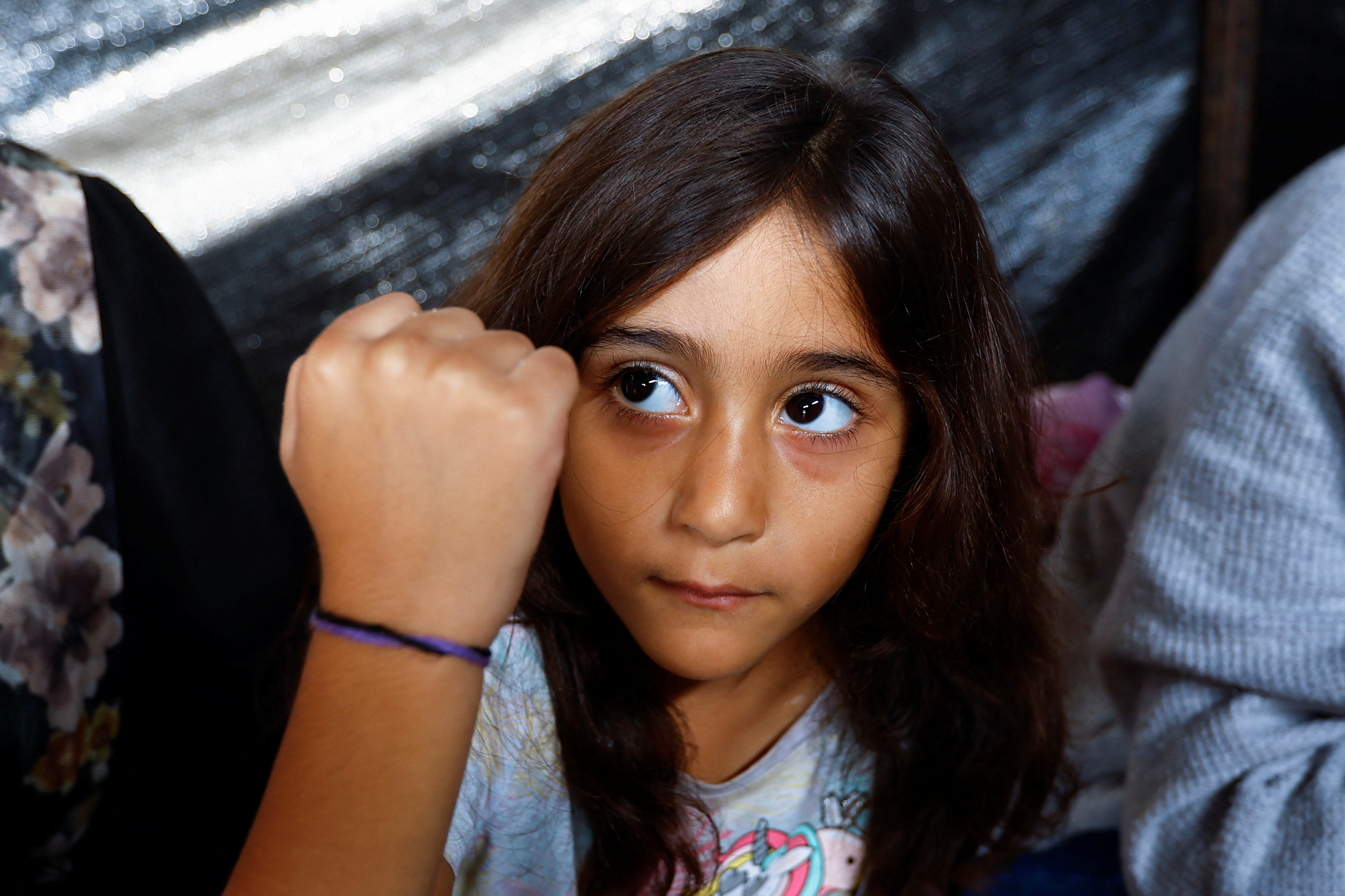 Gazan father marks his children with bracelets amid airstrikes in Khan Younis