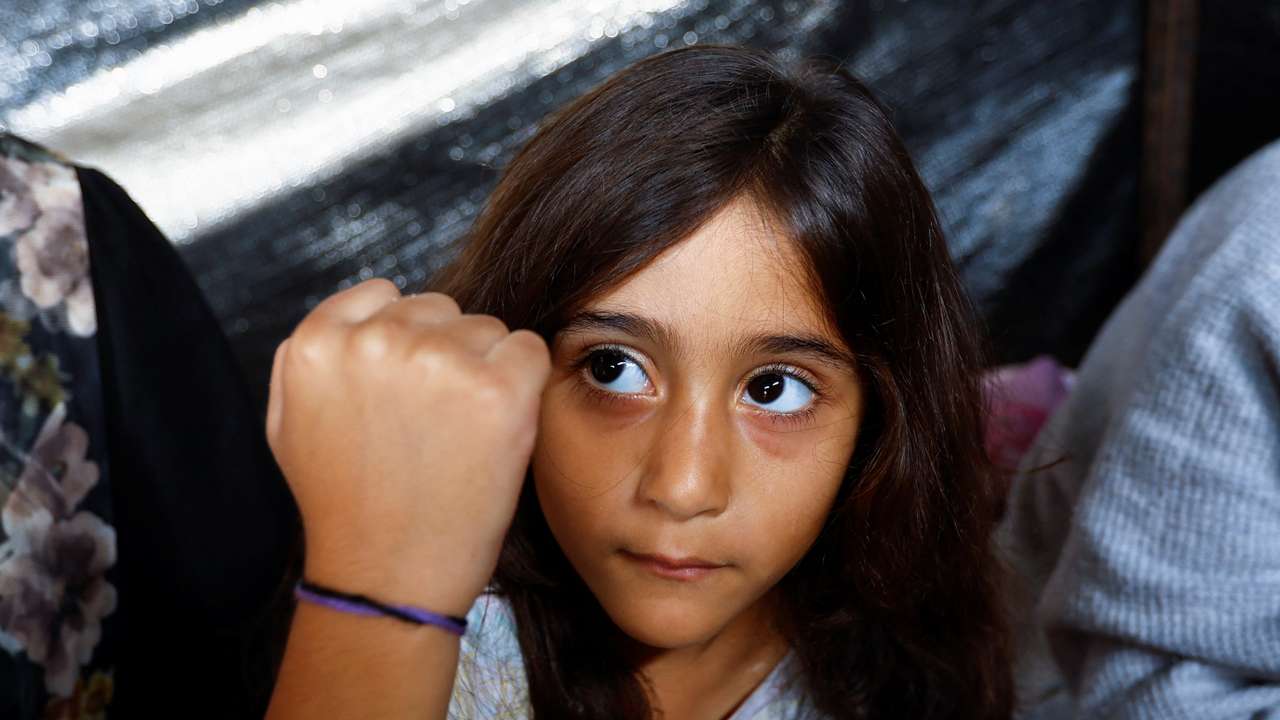 Gazan father marks his children with bracelets amid airstrikes in Khan Younis