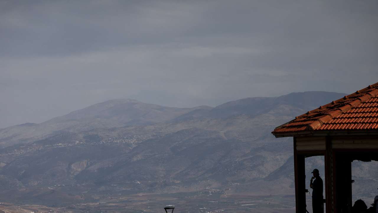 Israeli citizen looks out from a viewpoint towards Lebanon as seen from northern Israel
