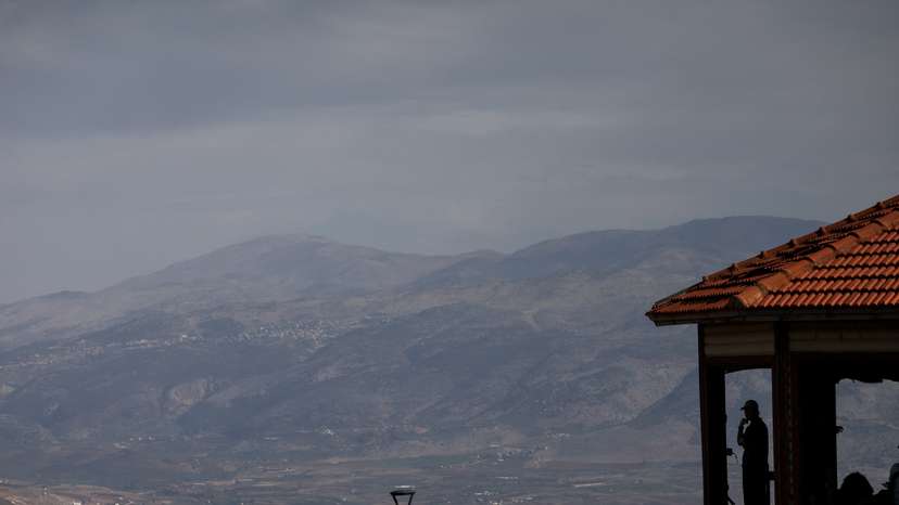 Israeli citizen looks out from a viewpoint towards Lebanon as seen from northern Israel