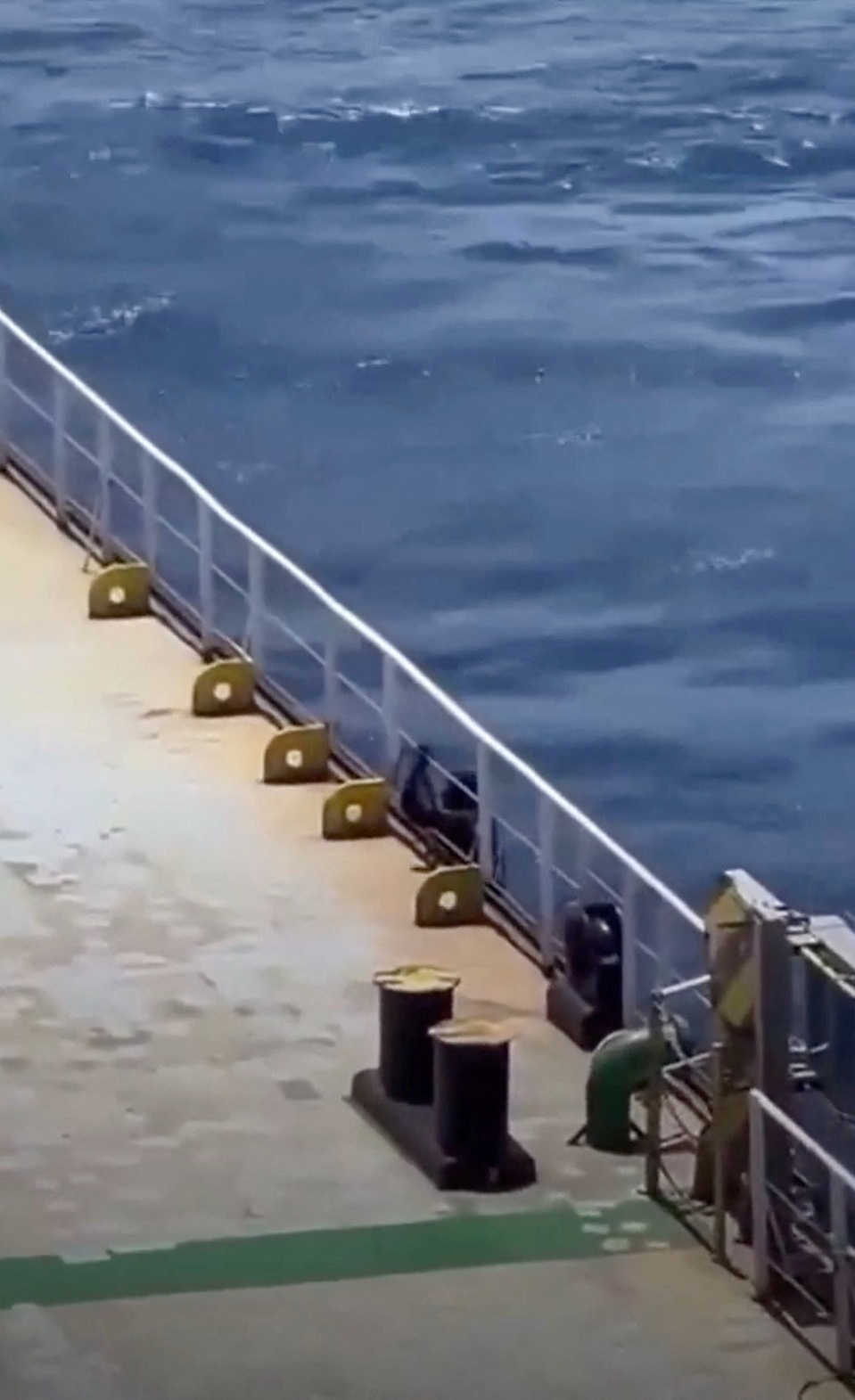 A person boards a shipping vessel MV Abdullah