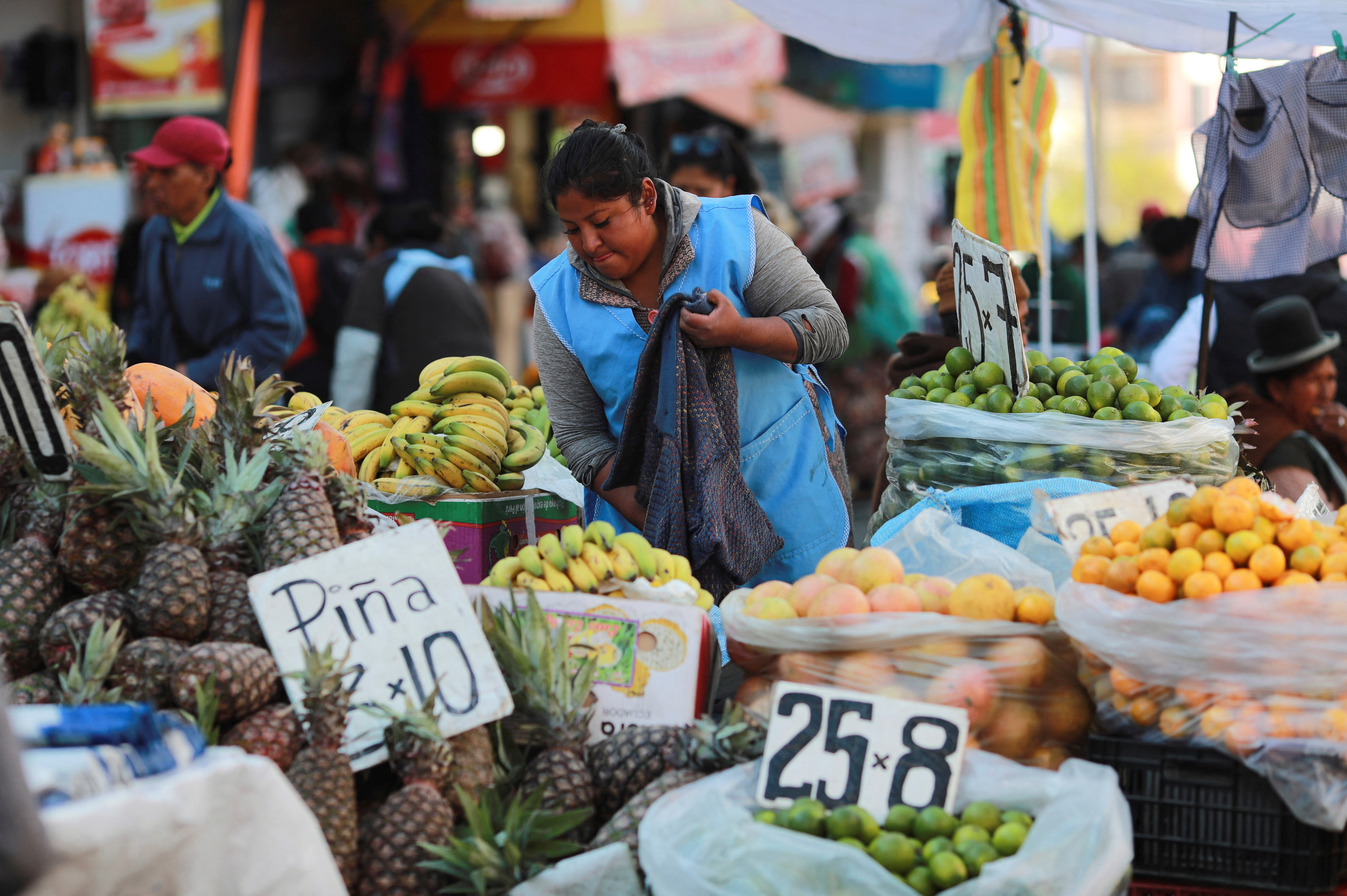 A street seller waits for customers along a street, in La Paz