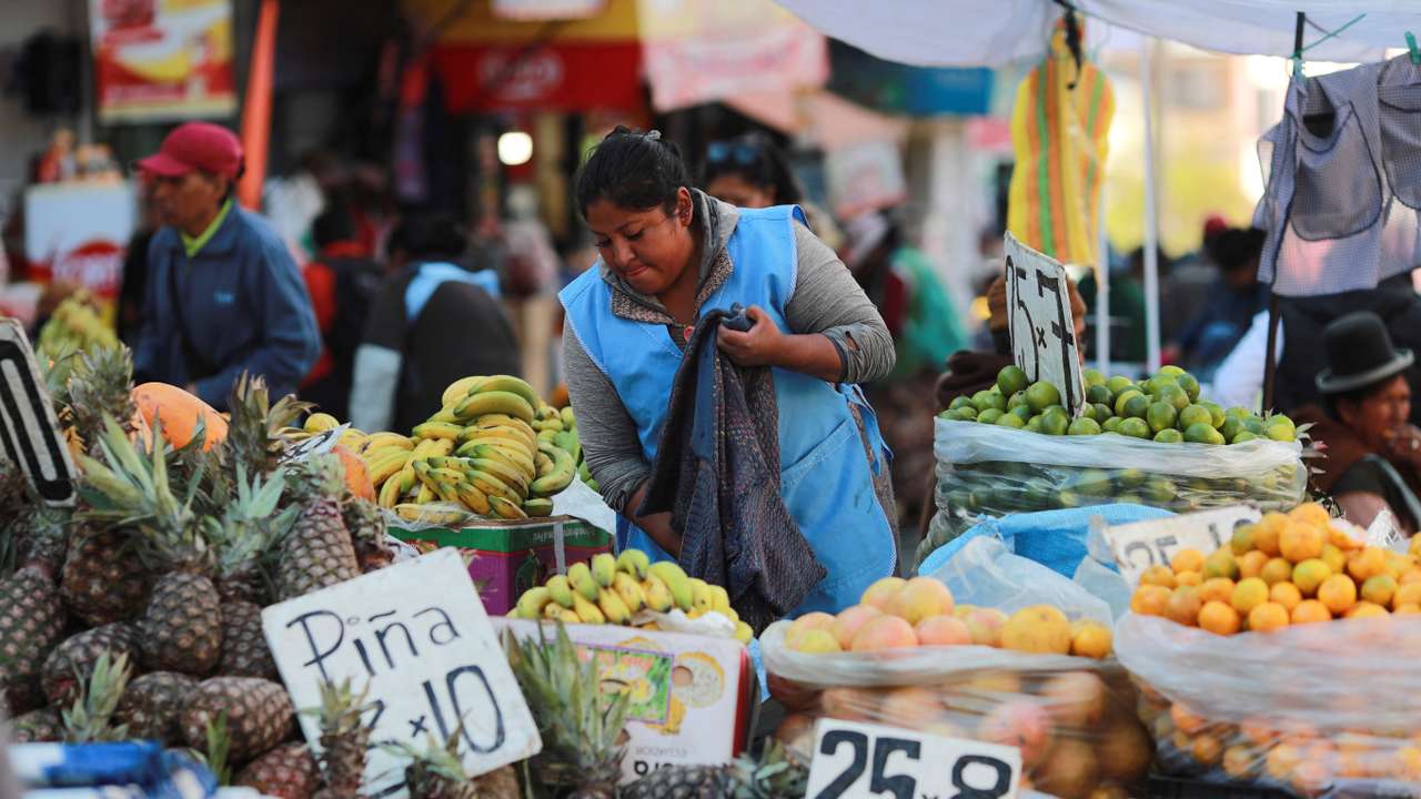 A street seller waits for customers along a street, in La Paz