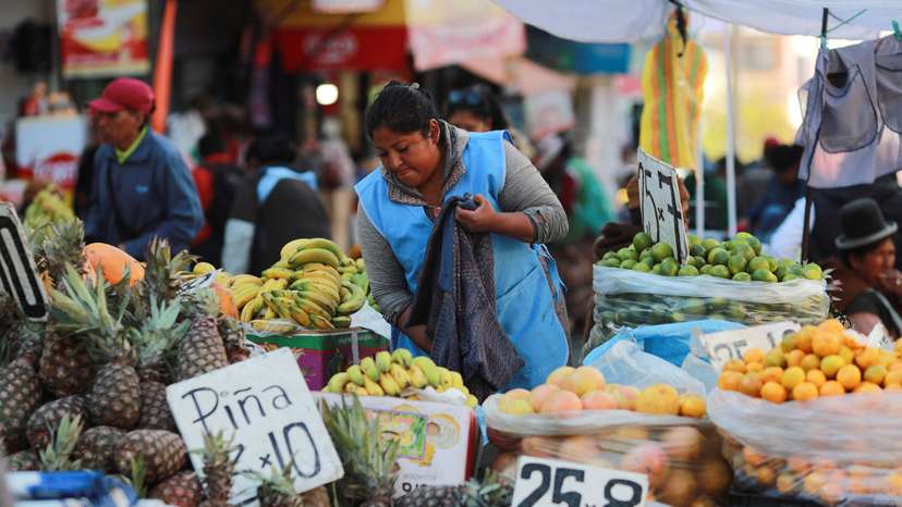 A street seller waits for customers along a street, in La Paz