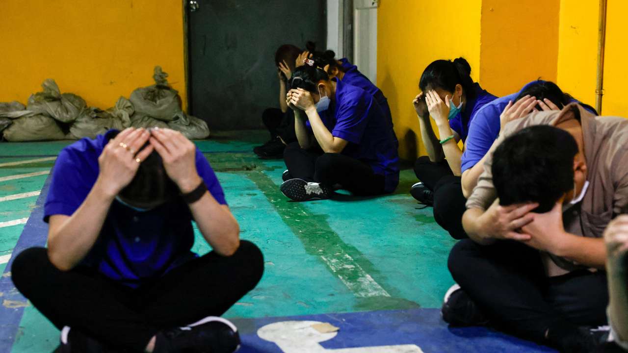 Hotel staff take shelter at the parking lot during an annual air-raid exercise in Hsinchu