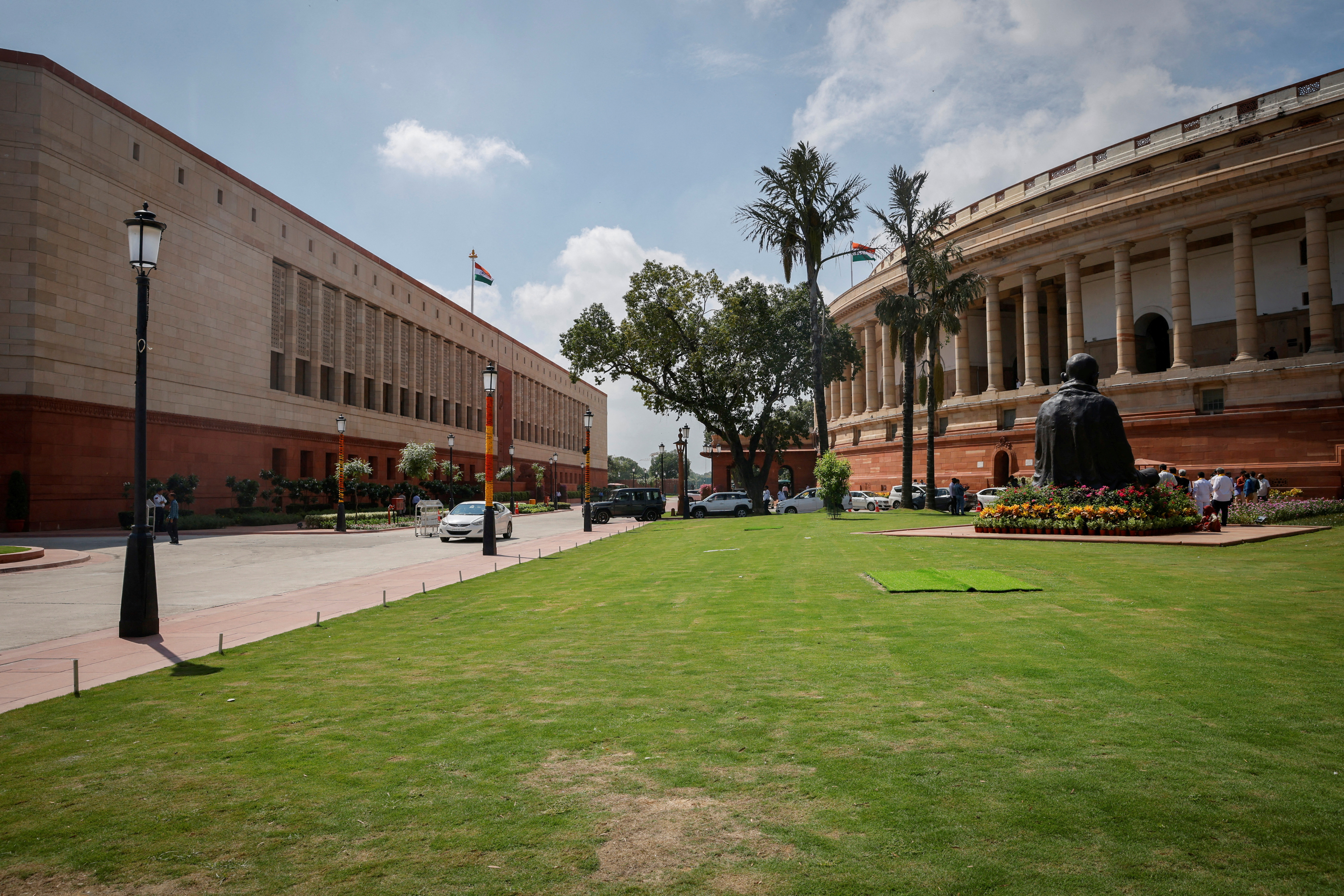 FILE PHOTO: A view shows India's new (L) and old parliament buildings during the first day of the five-day long special session in New Delhi