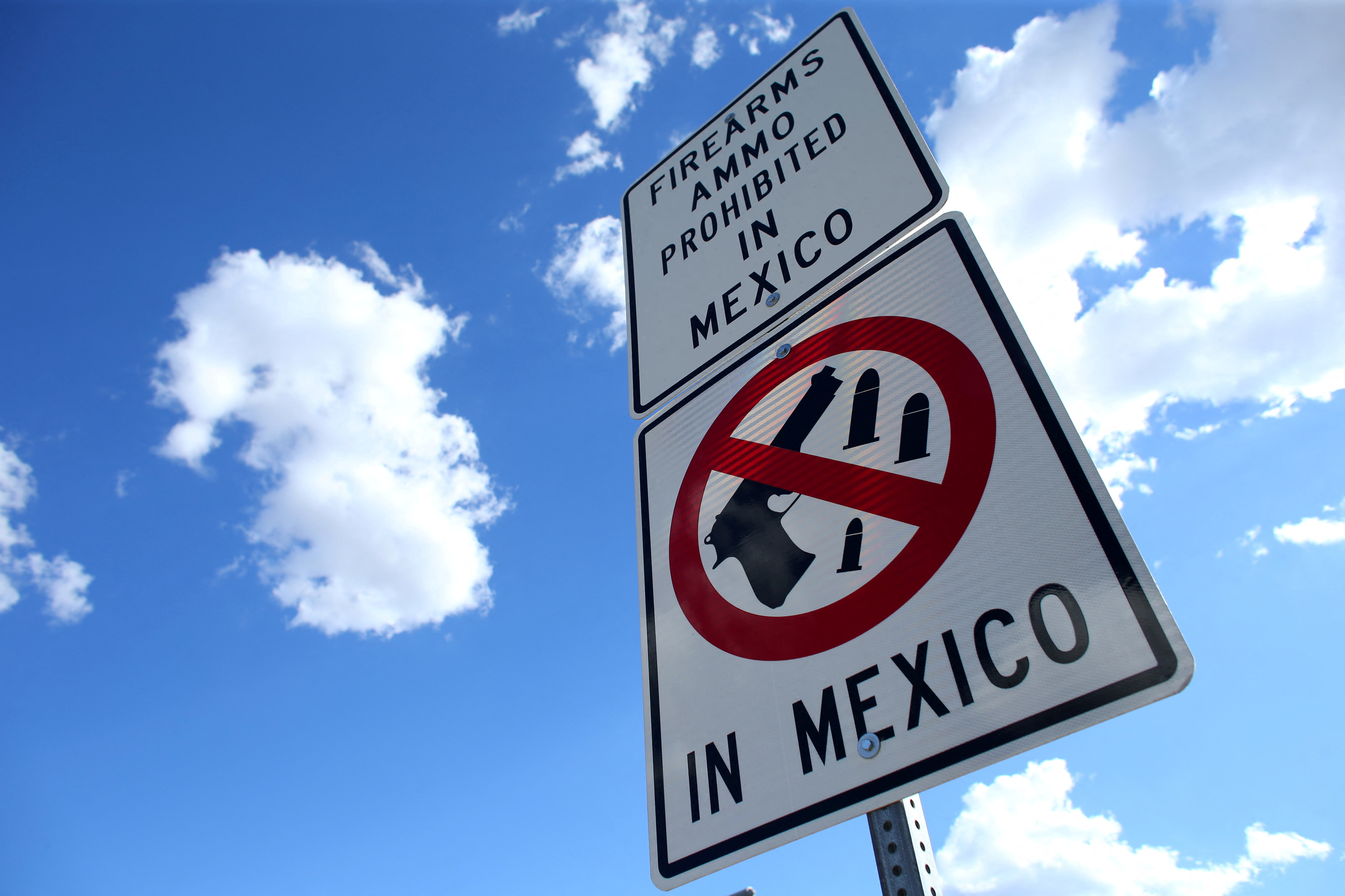 FILE PHOTO: A sign warns that firearms and ammunition are barred in Mexico