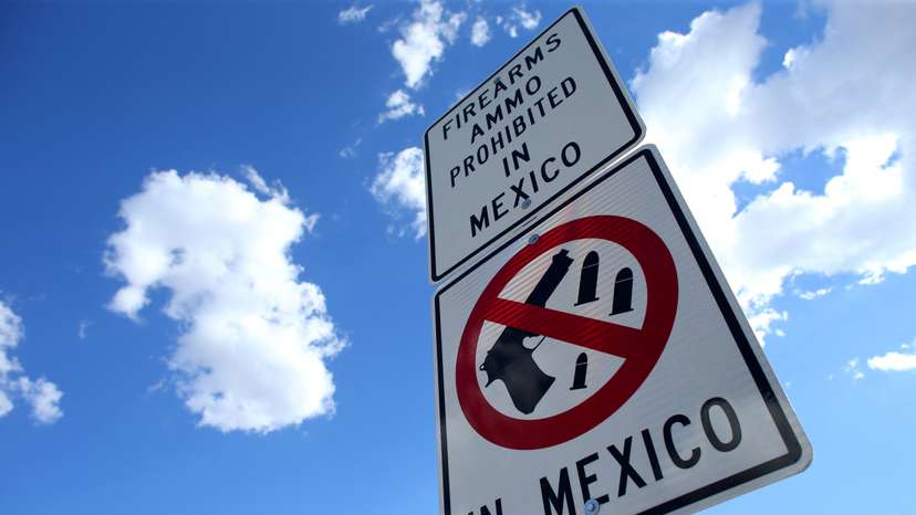 FILE PHOTO: A sign warns that firearms and ammunition are barred in Mexico