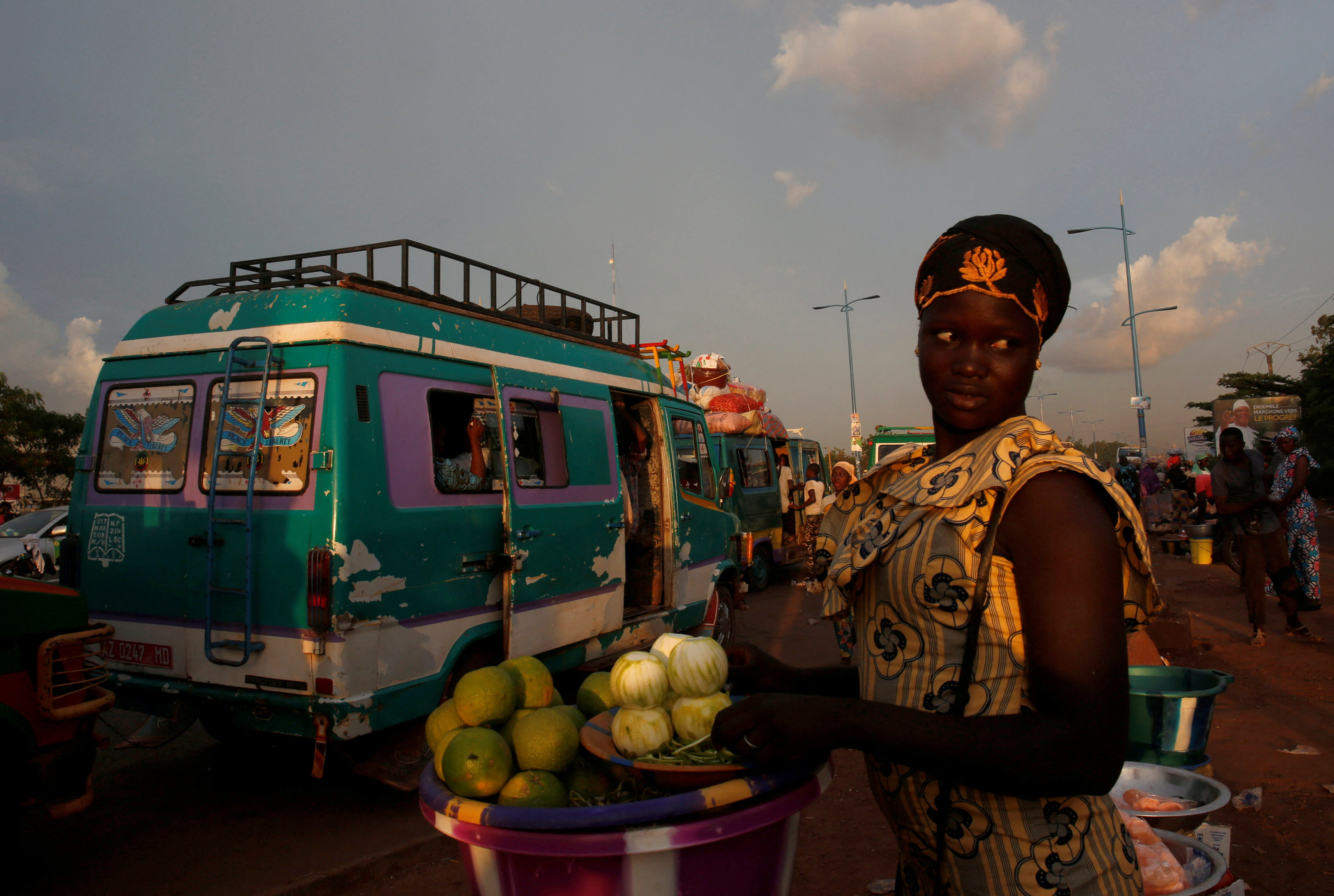 FILE PHOTO: A street vendor sells oranges at a mini bus station in Bamako, Mali