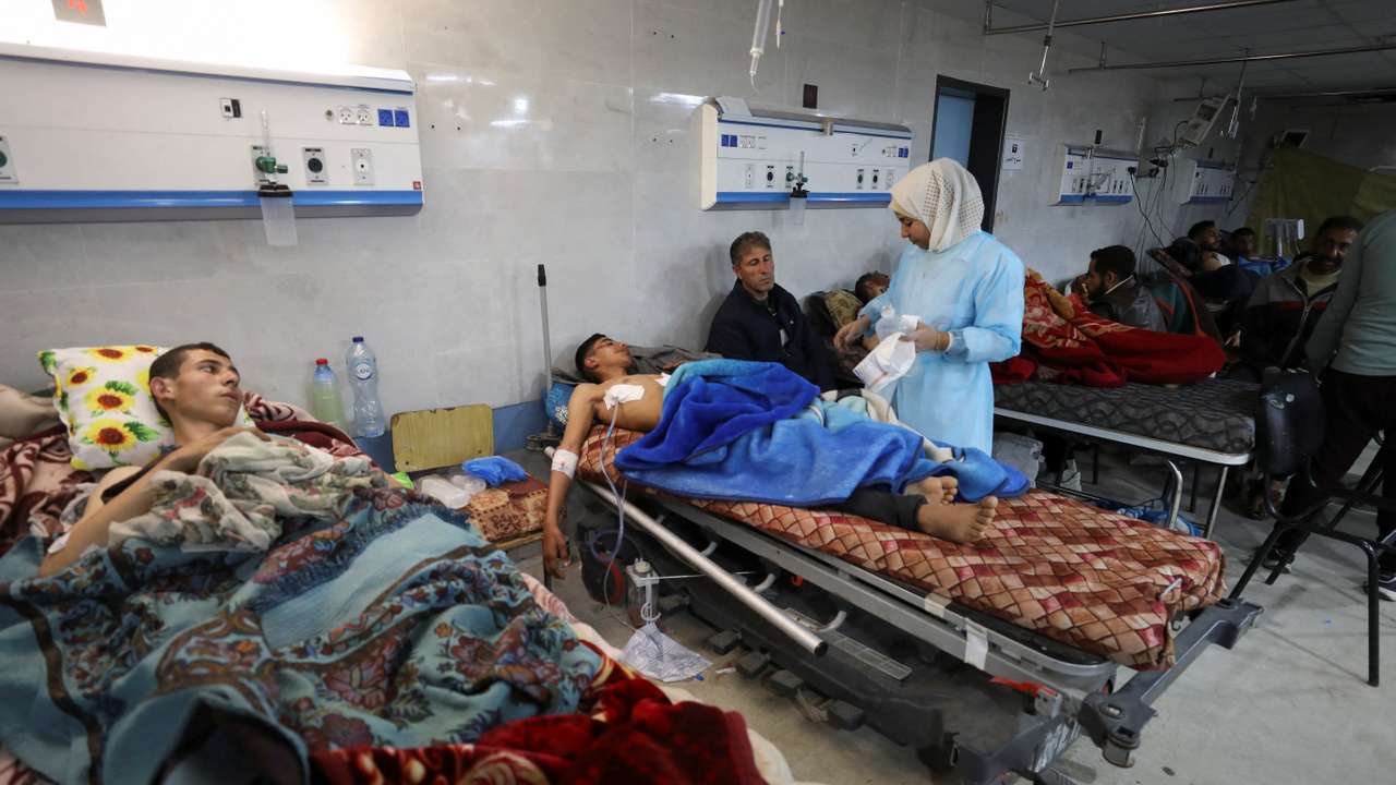 Palestinians who were wounded in Israeli fire while waiting for aid, according to health officials, lie on beds at Al Shifa hospital, amid the ongoing conflict between Israel and Hamas, in Gaza City