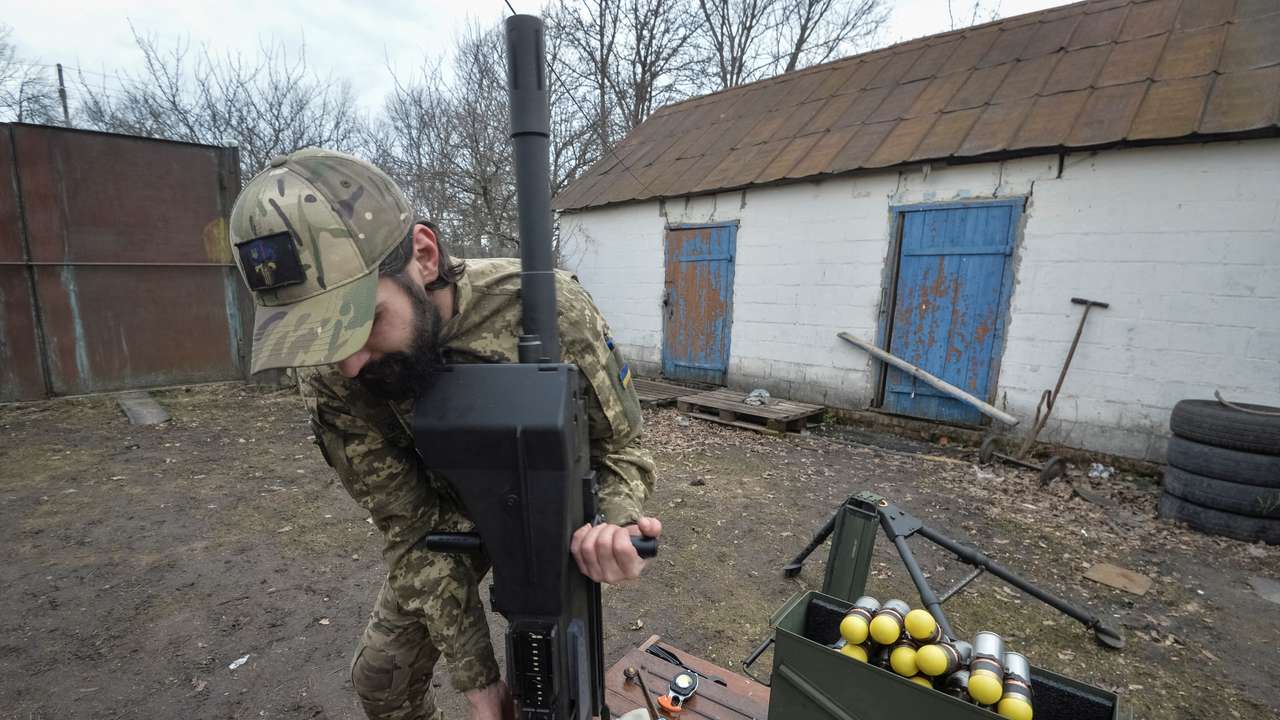FILE PHOTO: A serviceman of the Ukrainian Armed Forces works with a Mk 19 U.S. made automatic grenade launcher near the frontline town of Vovchansk