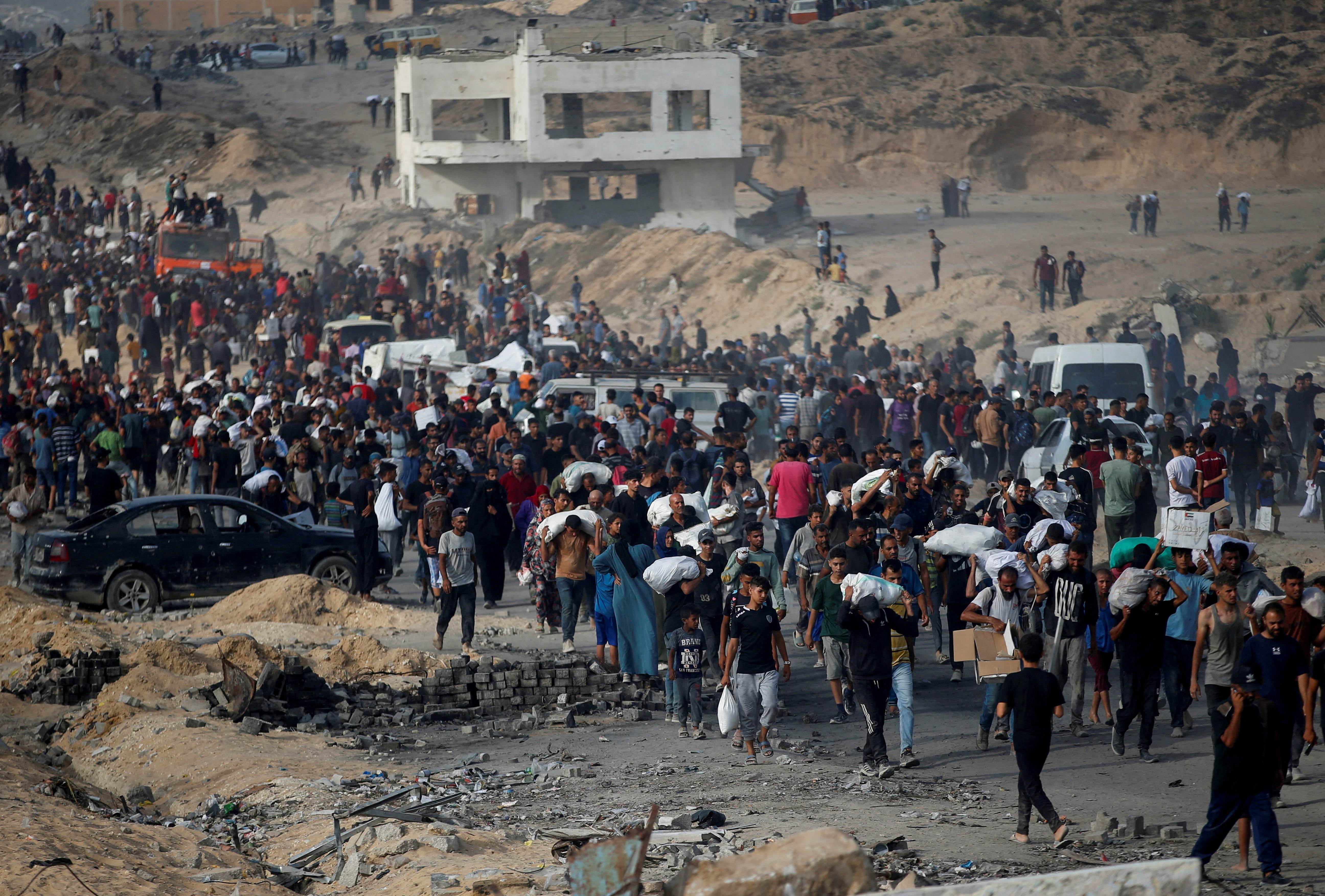 FILE PHOTO: Palestinians gather to receive aid supplies, in Beit Lahia