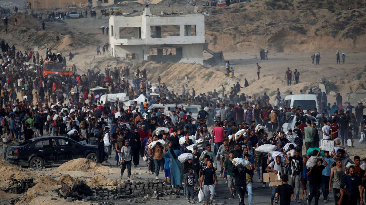 FILE PHOTO: Palestinians gather to receive aid supplies, in Beit Lahia