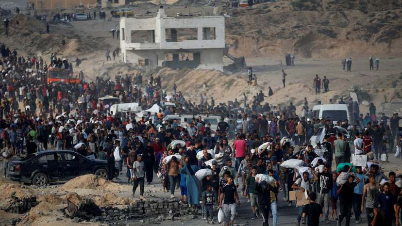FILE PHOTO: Palestinians gather to receive aid supplies, in Beit Lahia